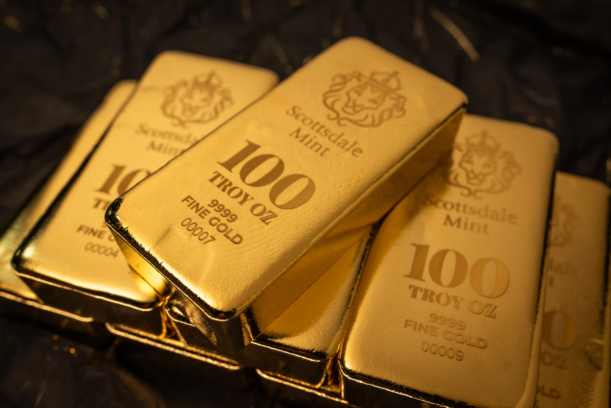 Stack of fine gold bars on dark background