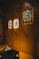 Framed art hangs on a wood-paneled wall.