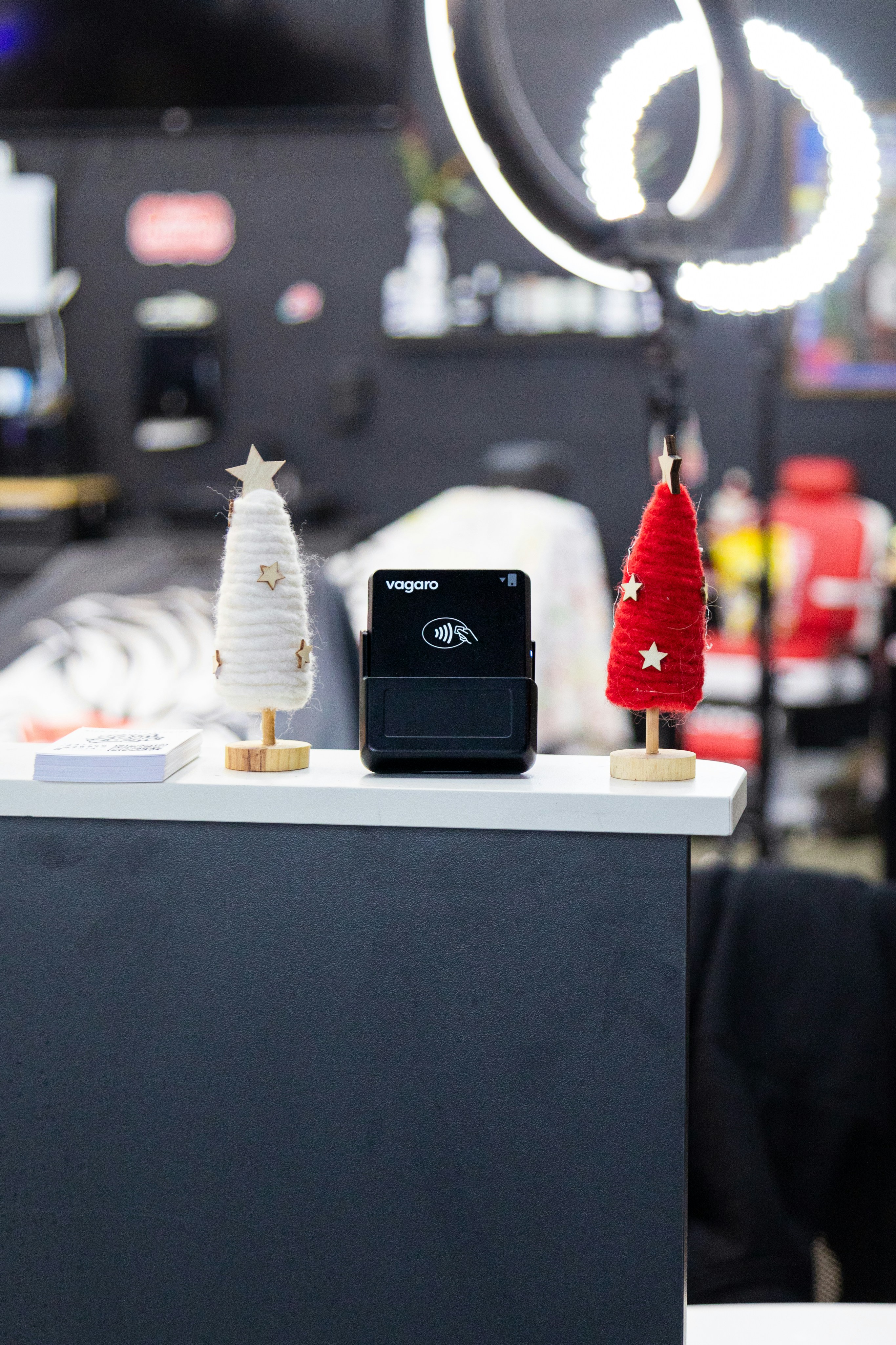 Two festive christmas trees flank a black device.