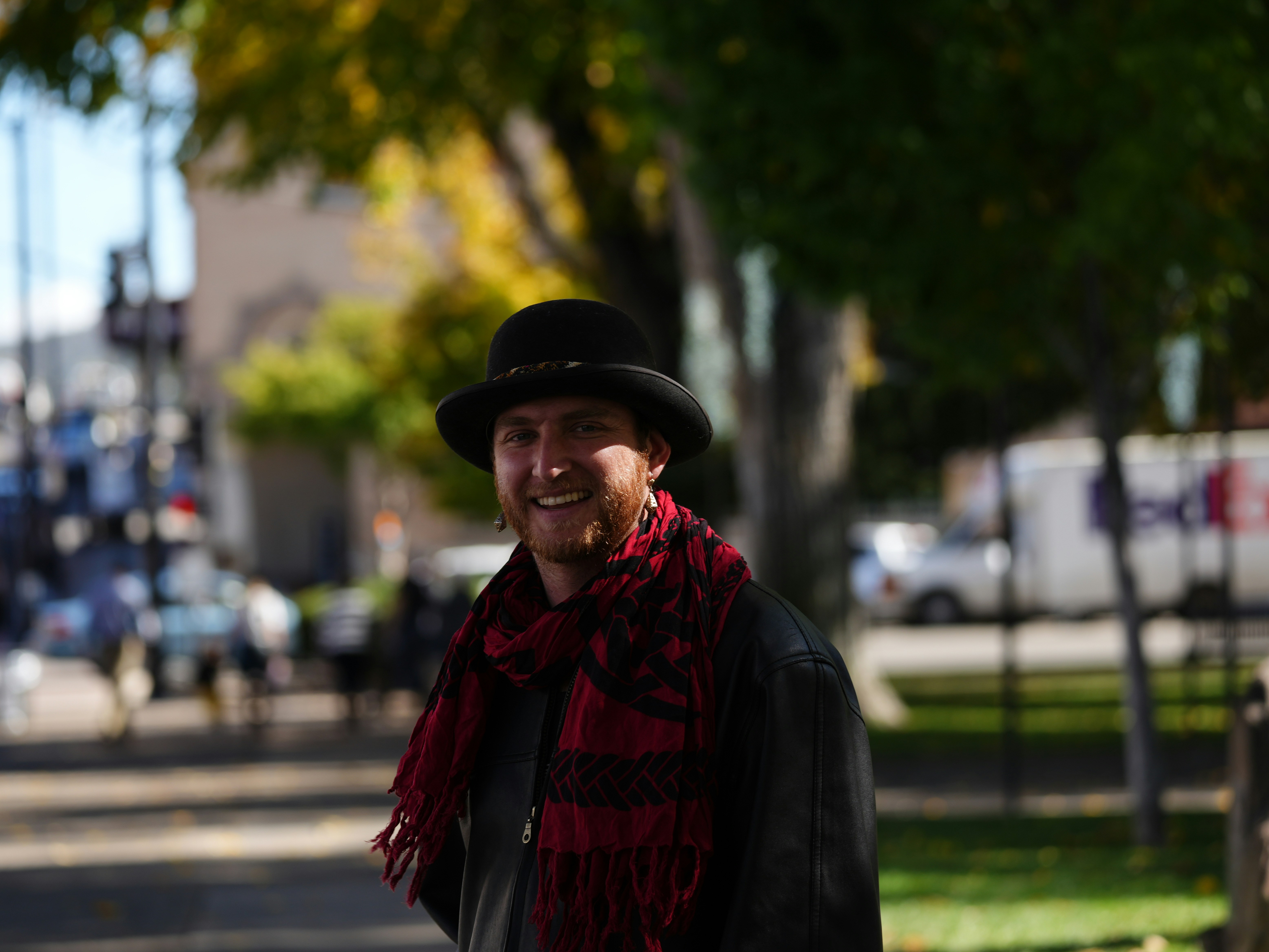 Man wearing a hat and scarf outdoors