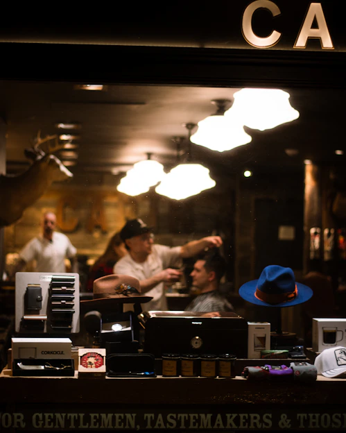 Barber cutting man's hair in vintage shop