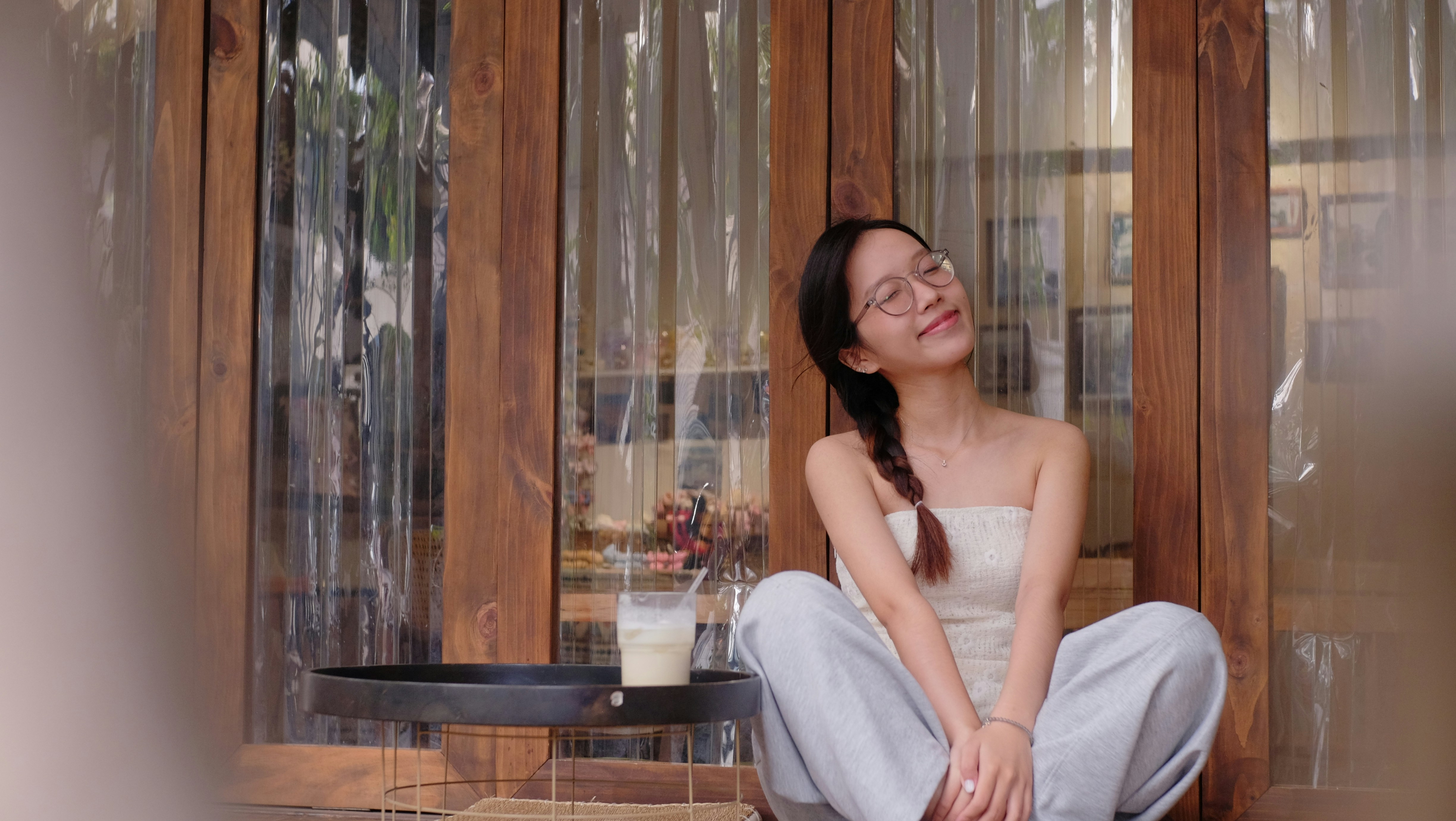 Young woman smiling while sitting outdoors