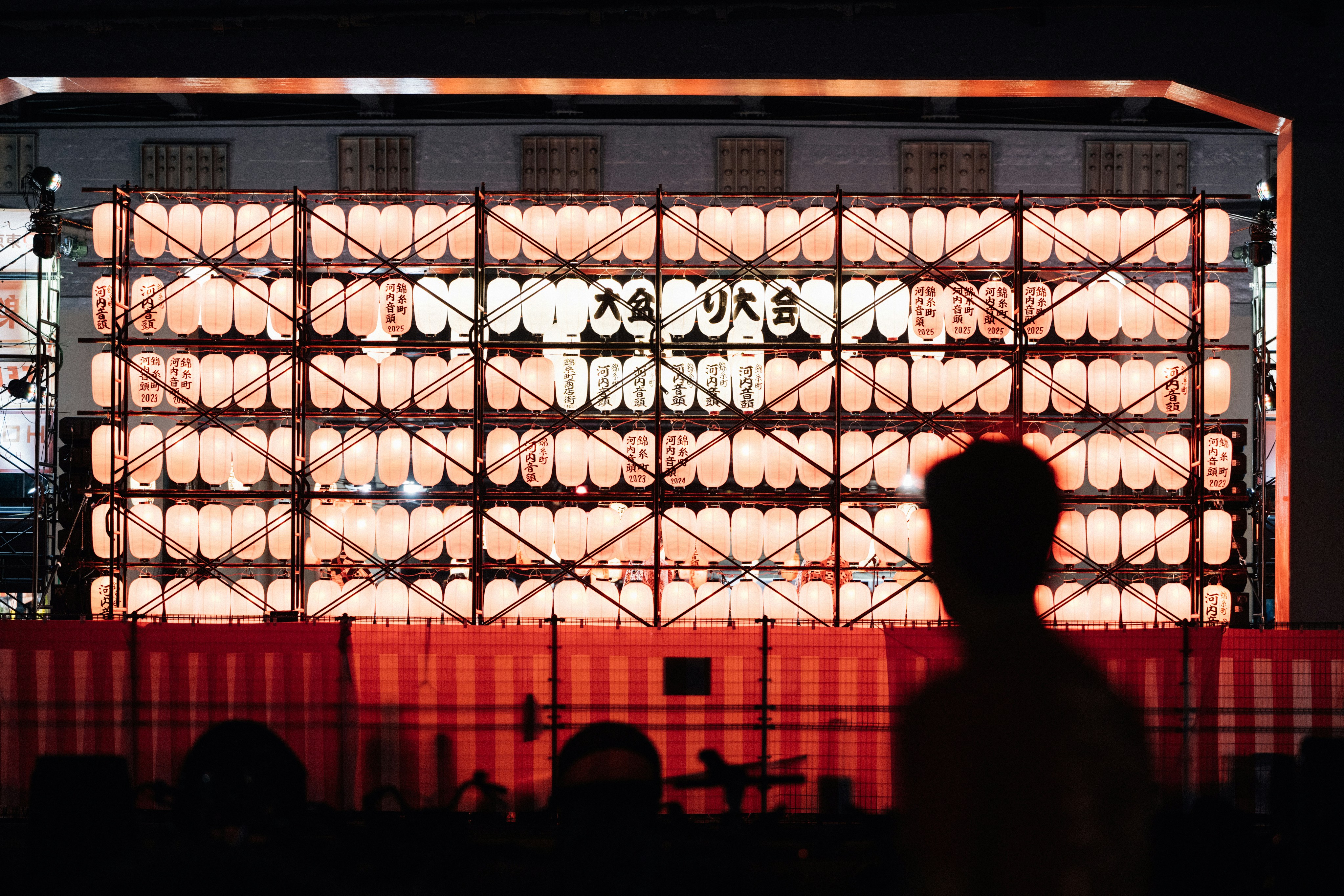 Illuminated building facade with grid pattern at night