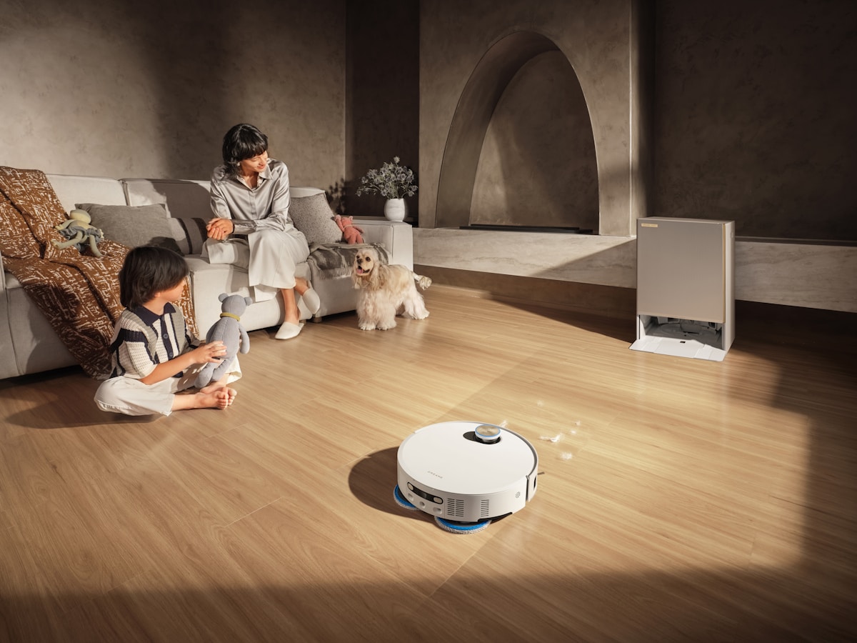 Robot vacuum cleans floor while family relaxes
