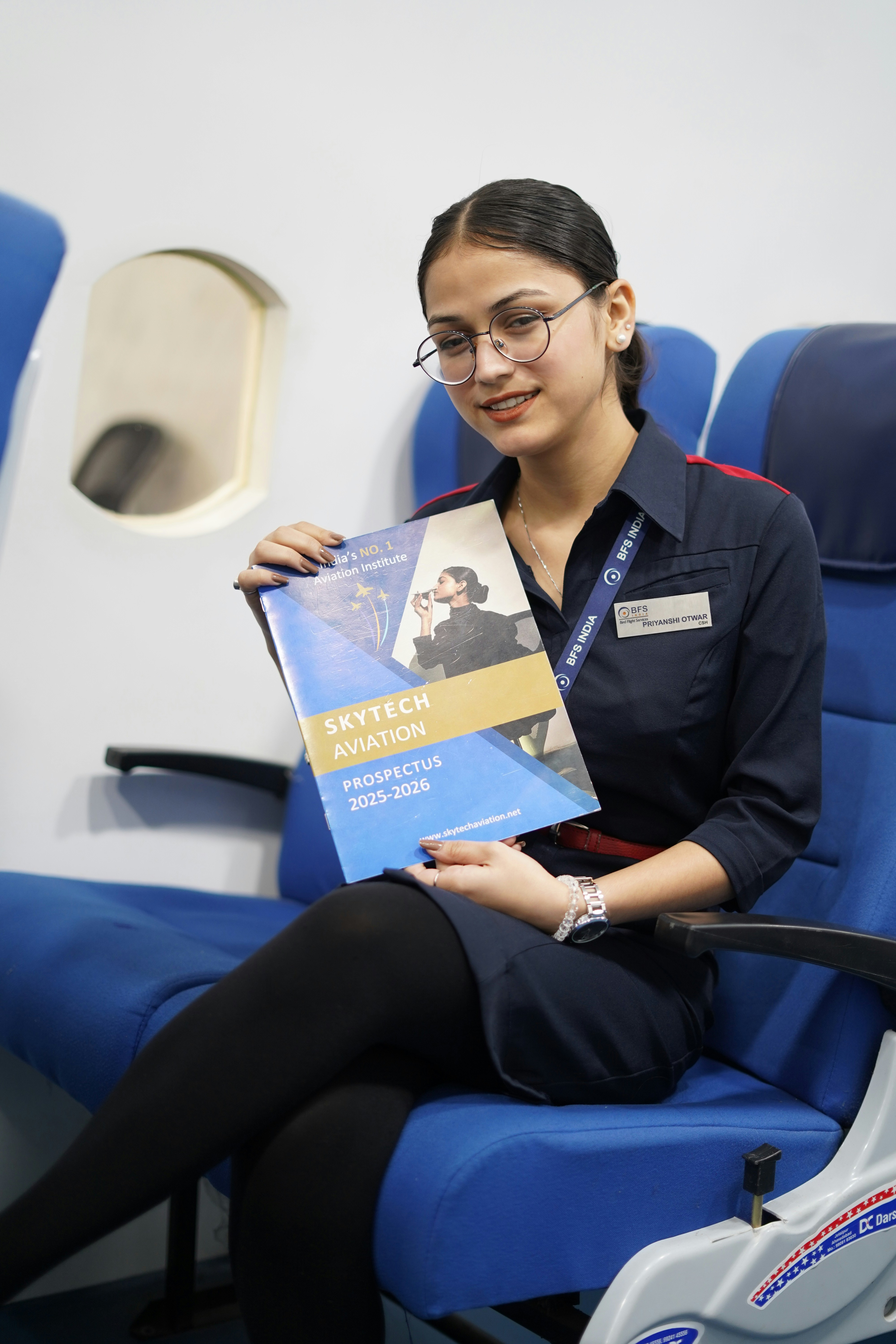 Young woman in uniform holding aviation prospectus