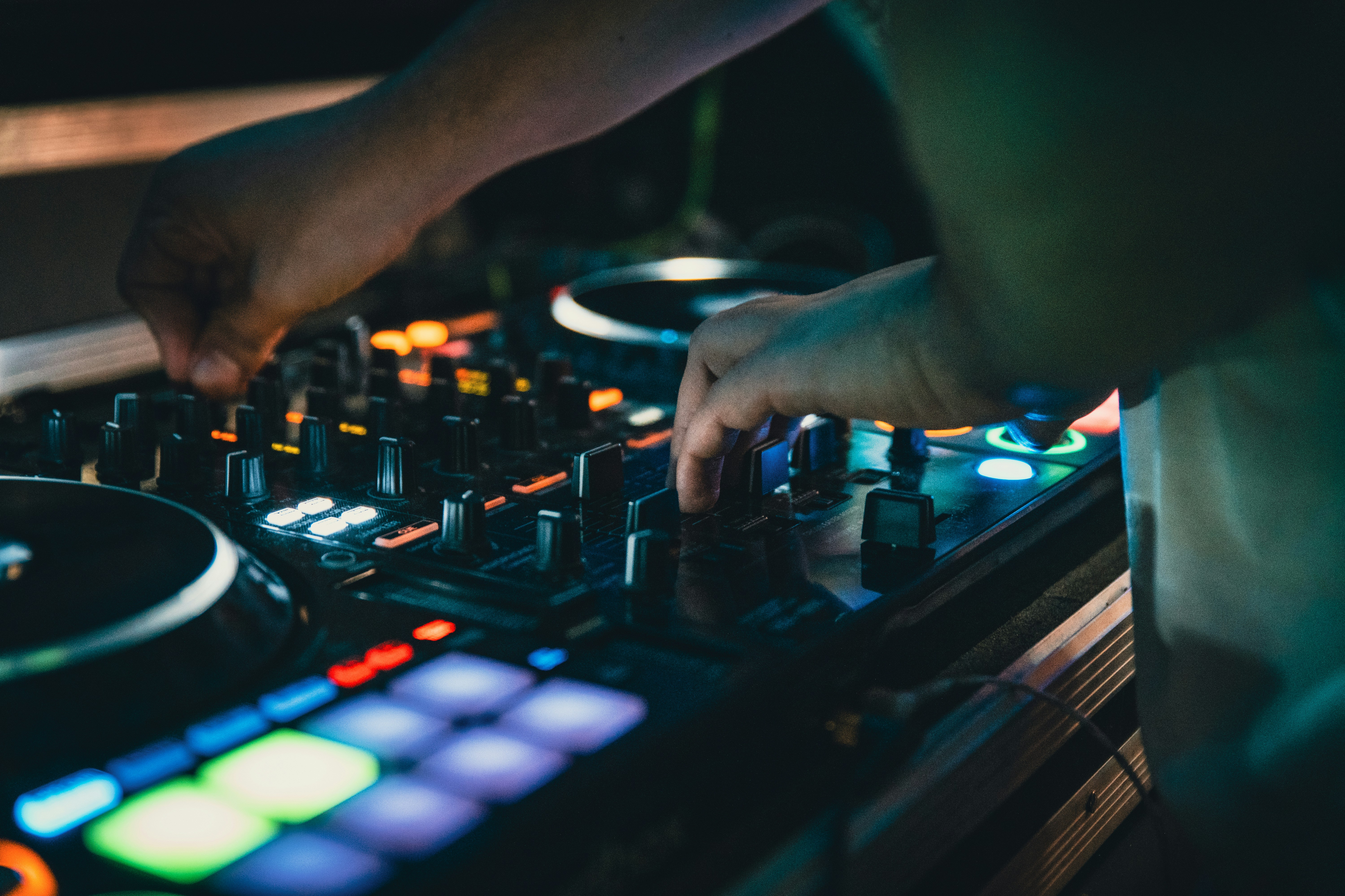 DJ hands adjusting controls