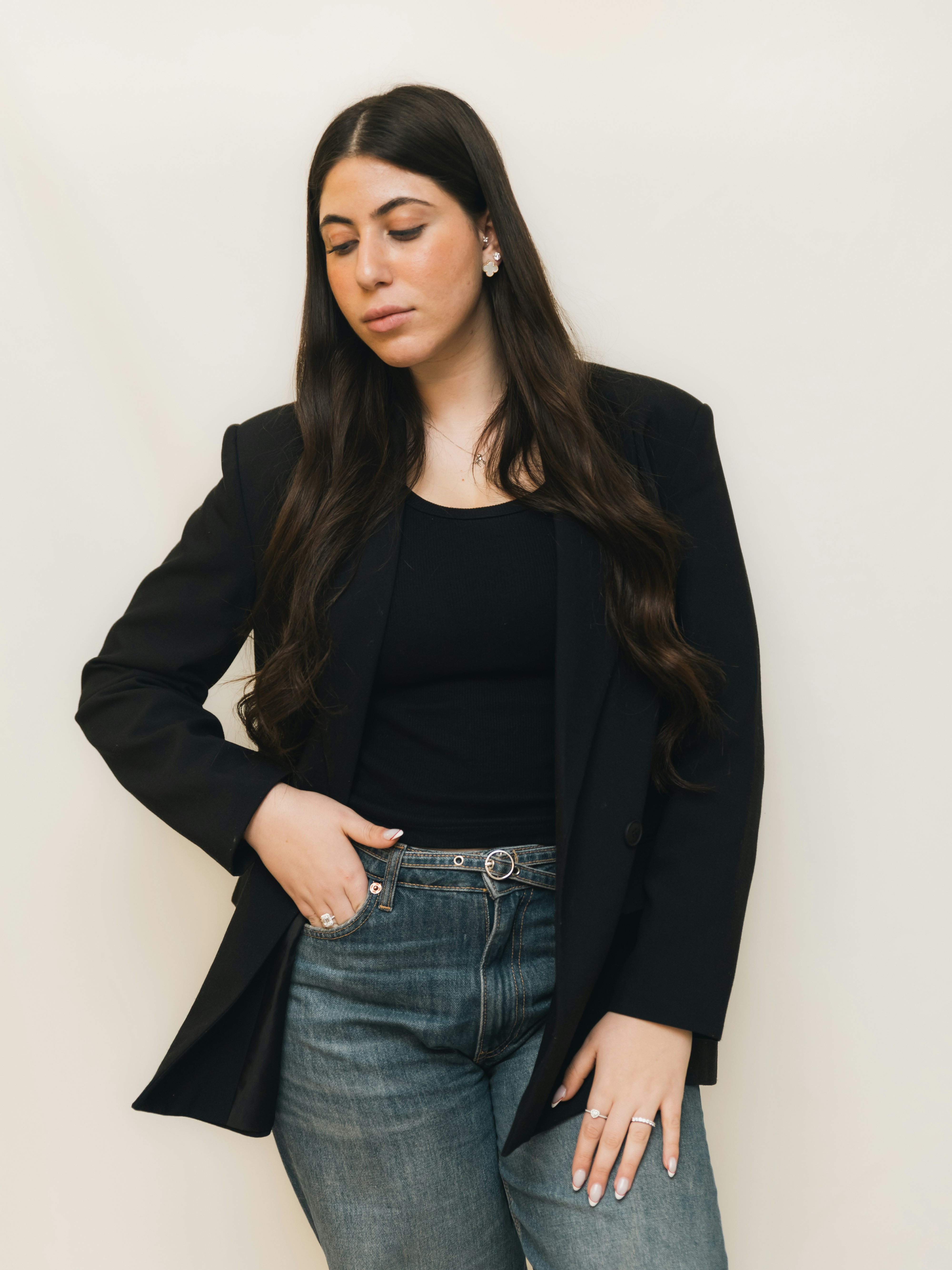 Young woman in black blazer and jeans