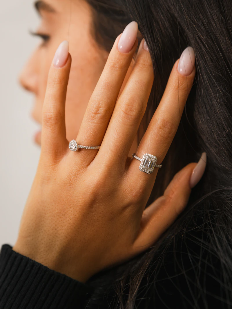 Adult woman's hand wearing slim diamond rings