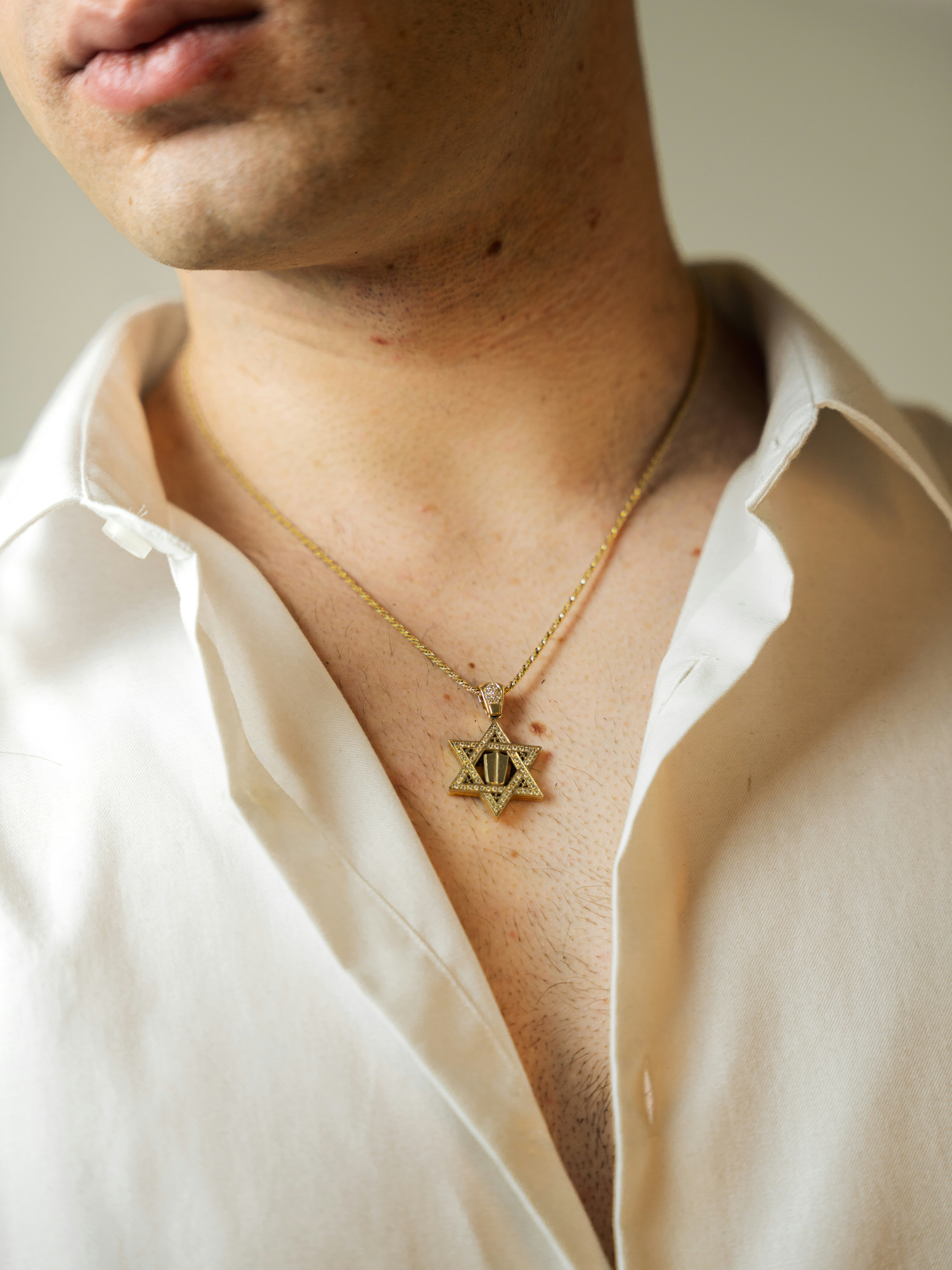 Man wearing a star of david necklace