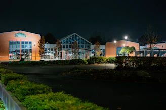 Modern building exterior at night with lights on