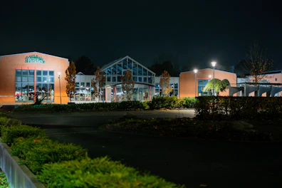 Modern building exterior at night with lights on