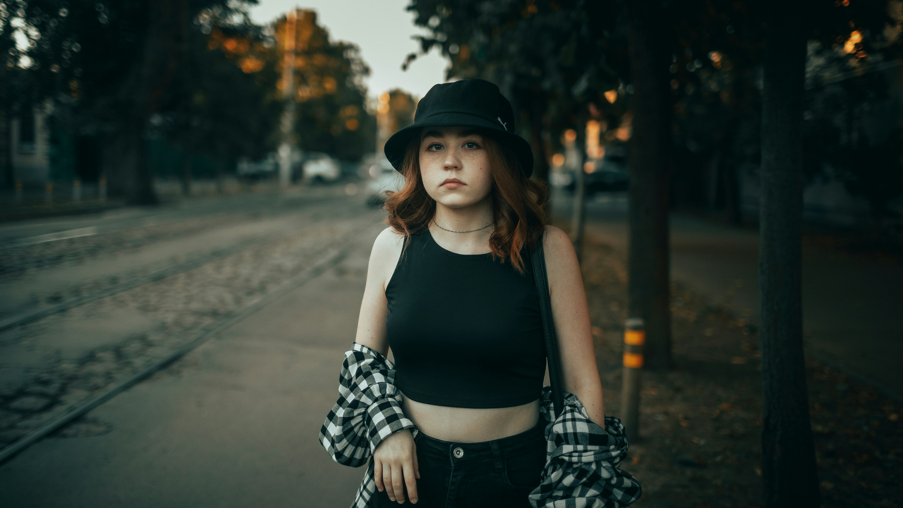 Young woman wearing a hat and crop top on street