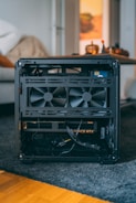 Open computer case with fans and graphics card.