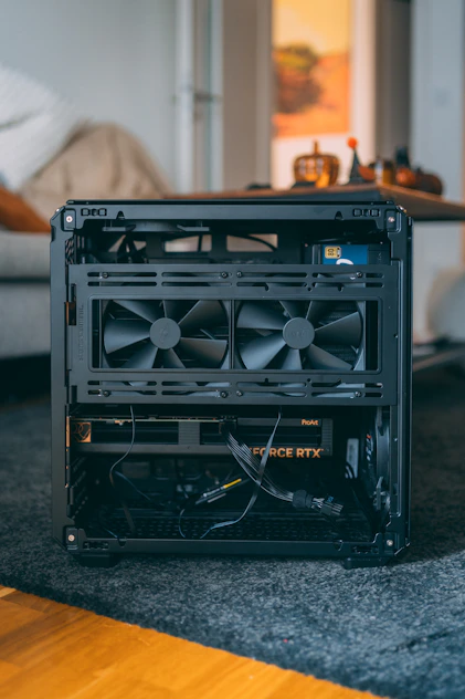 Open computer case with fans and graphics card.