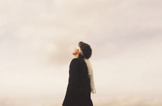 Woman looking up at cloudy sky