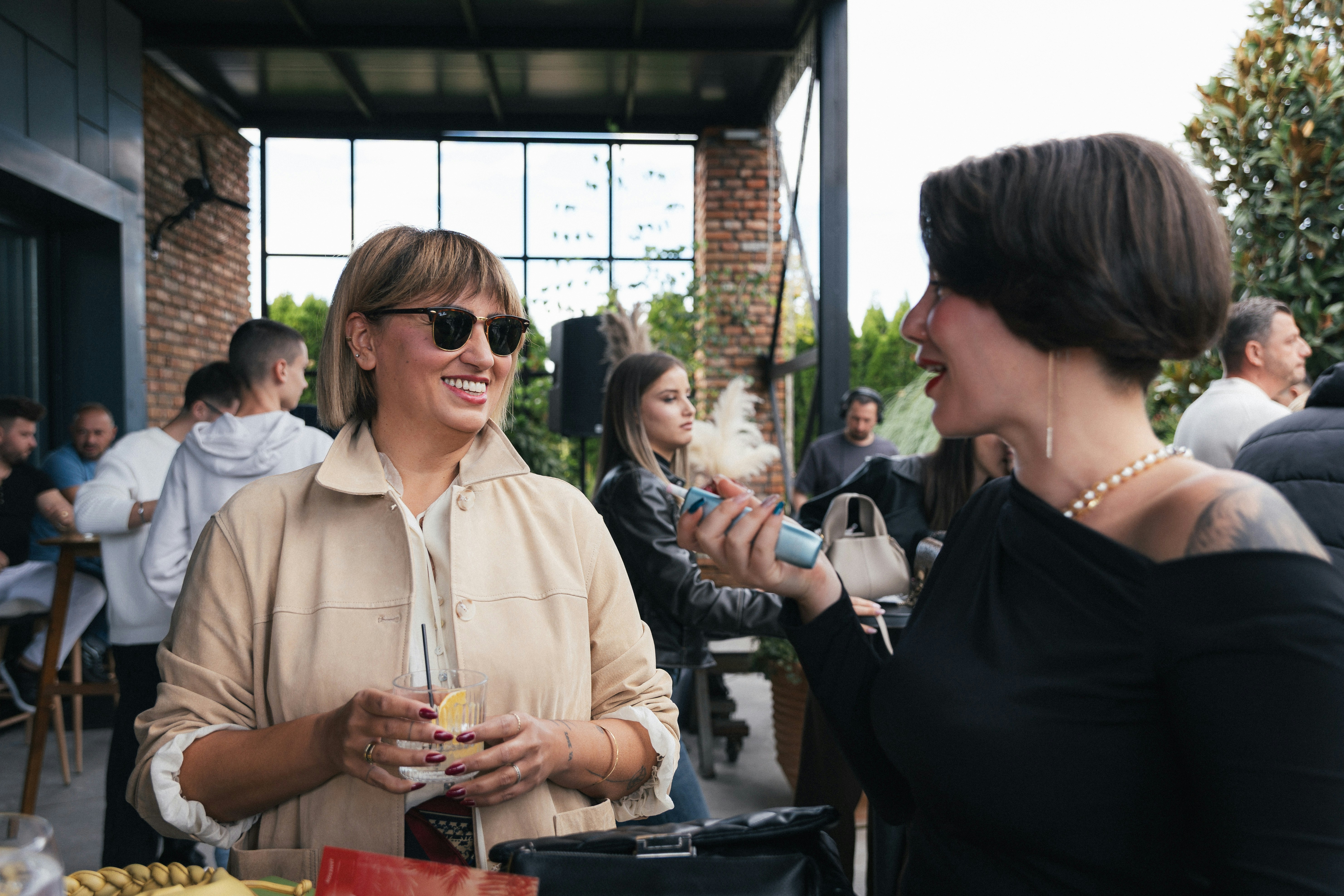Two women talking at an outdoor gathering