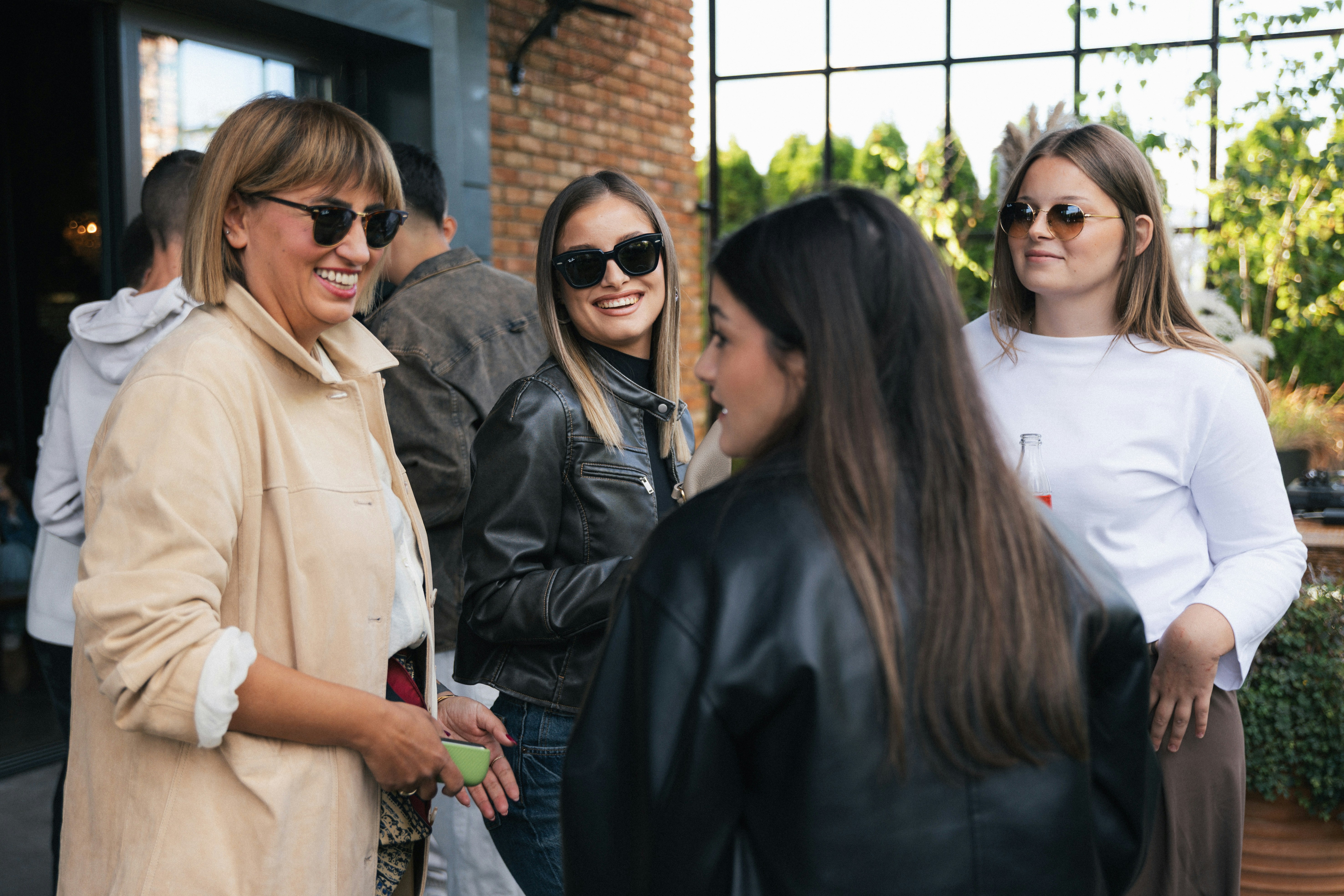 Group of friends chatting outdoors on a sunny day