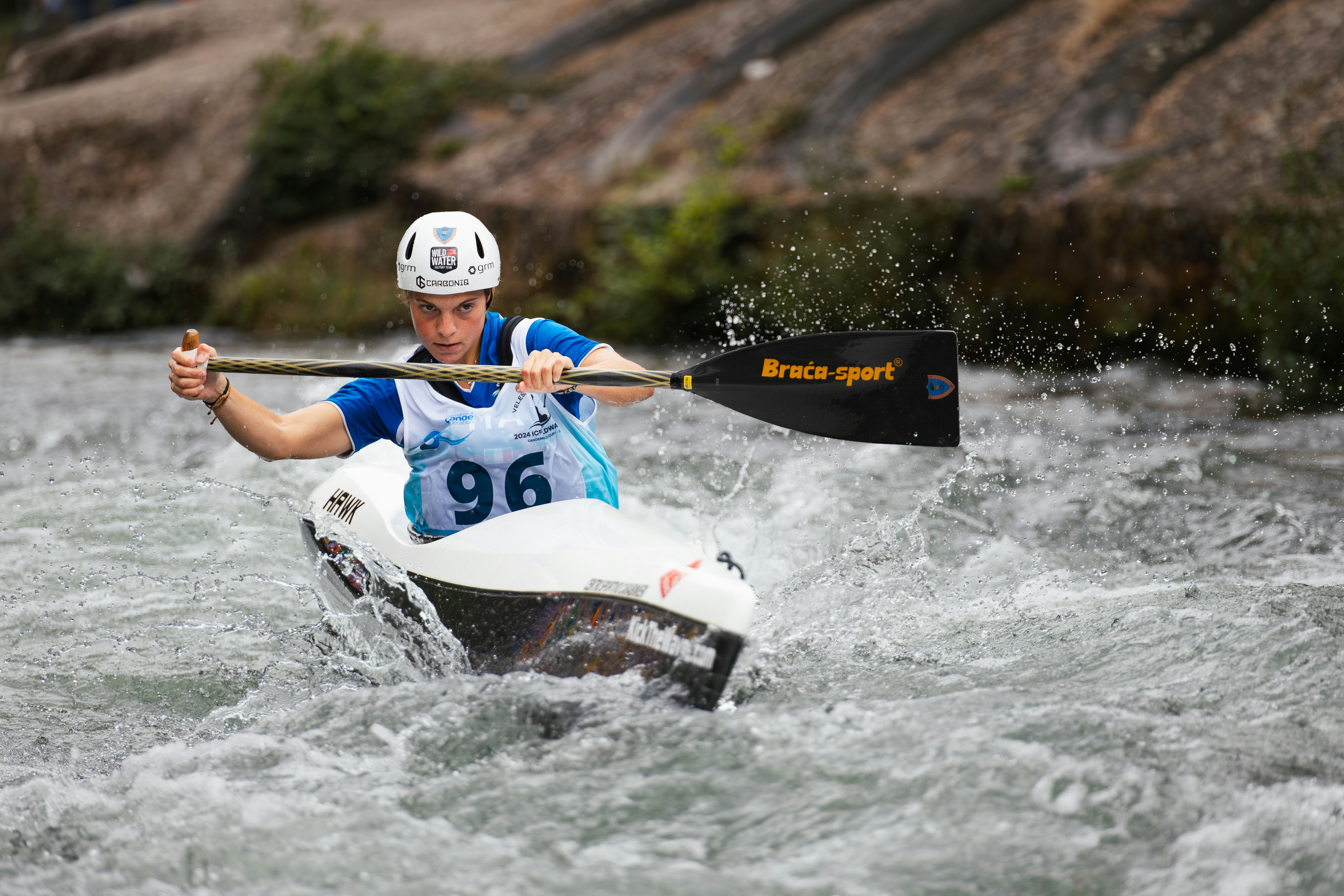 Man in kayak navigates whitewater rapids