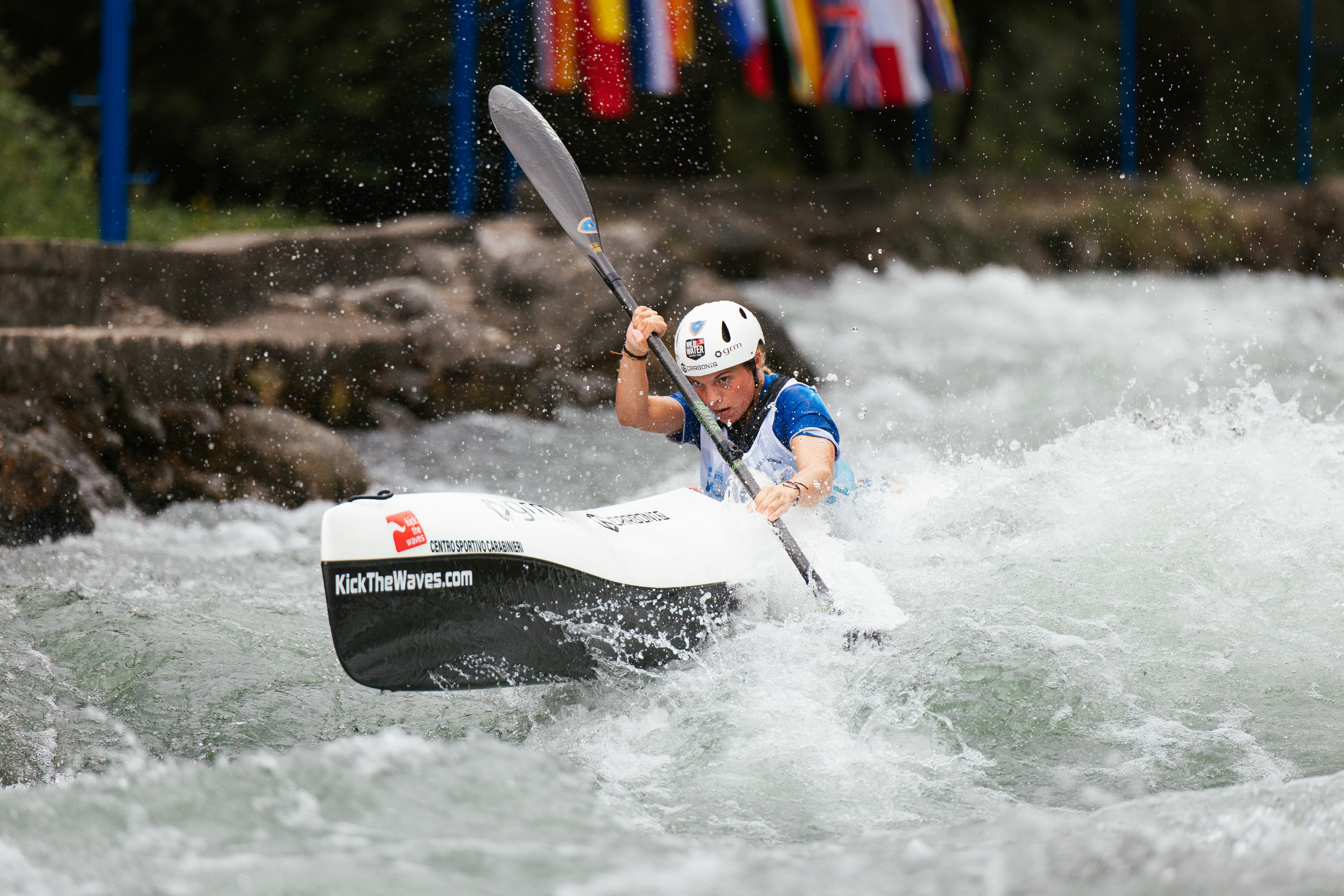 Person kayaking through whitewater rapids