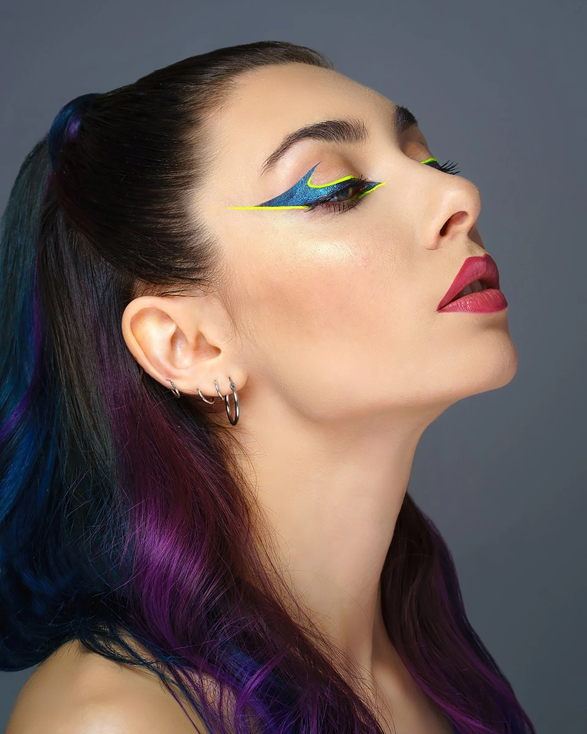 Woman with colorful hair and graphic eyeliner