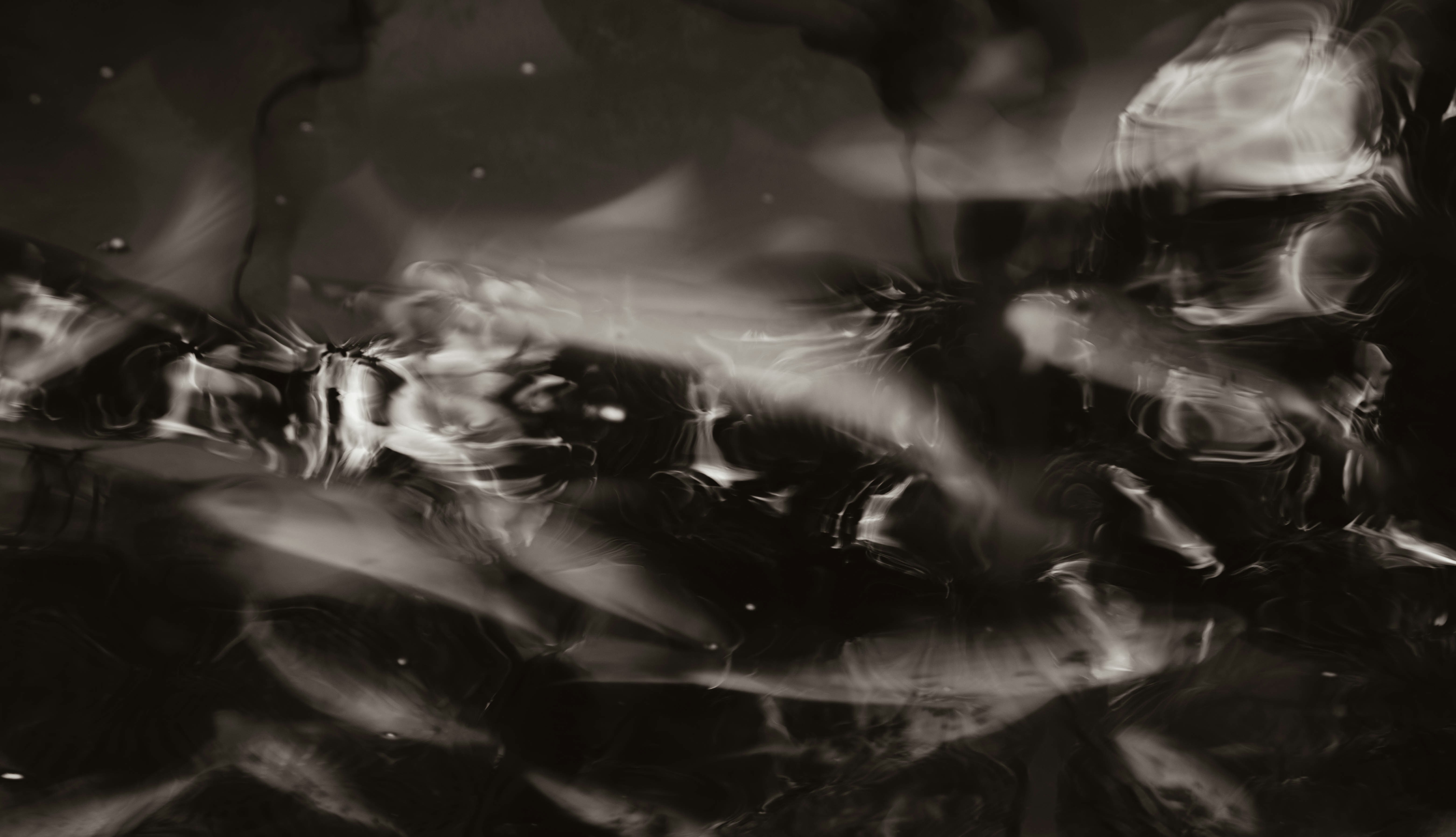 Abstract dark background with shimmering light reflections.