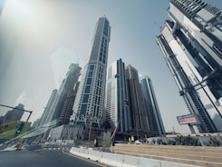 Modern skyscrapers rise against a clear blue sky.