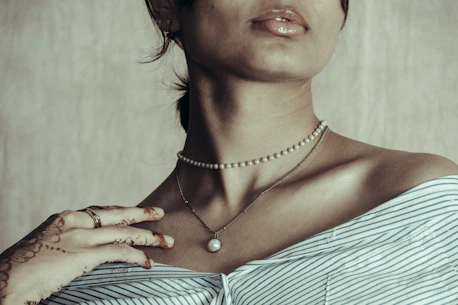 Woman wearing pearl necklaces and striped shirt