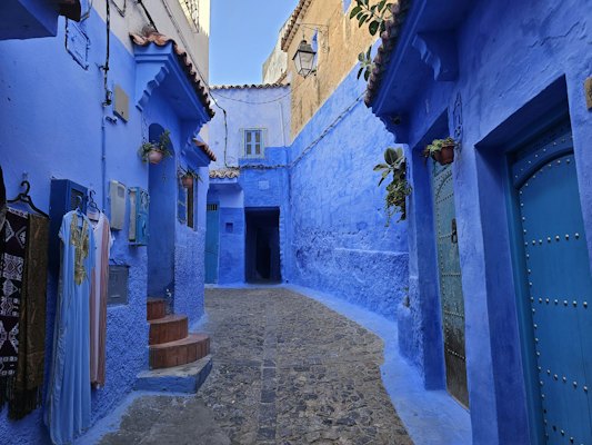 Narrow alleyway with blue walls and doors — Chefchaouen, Morocco