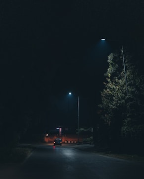 Car driving on a dark street at night with flat tire risk