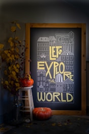 Chalkboard art says "let's explore the world"