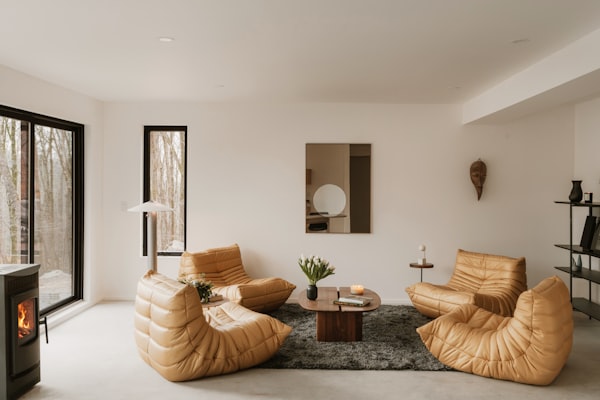 Modern living room with leather chairs and fireplace
