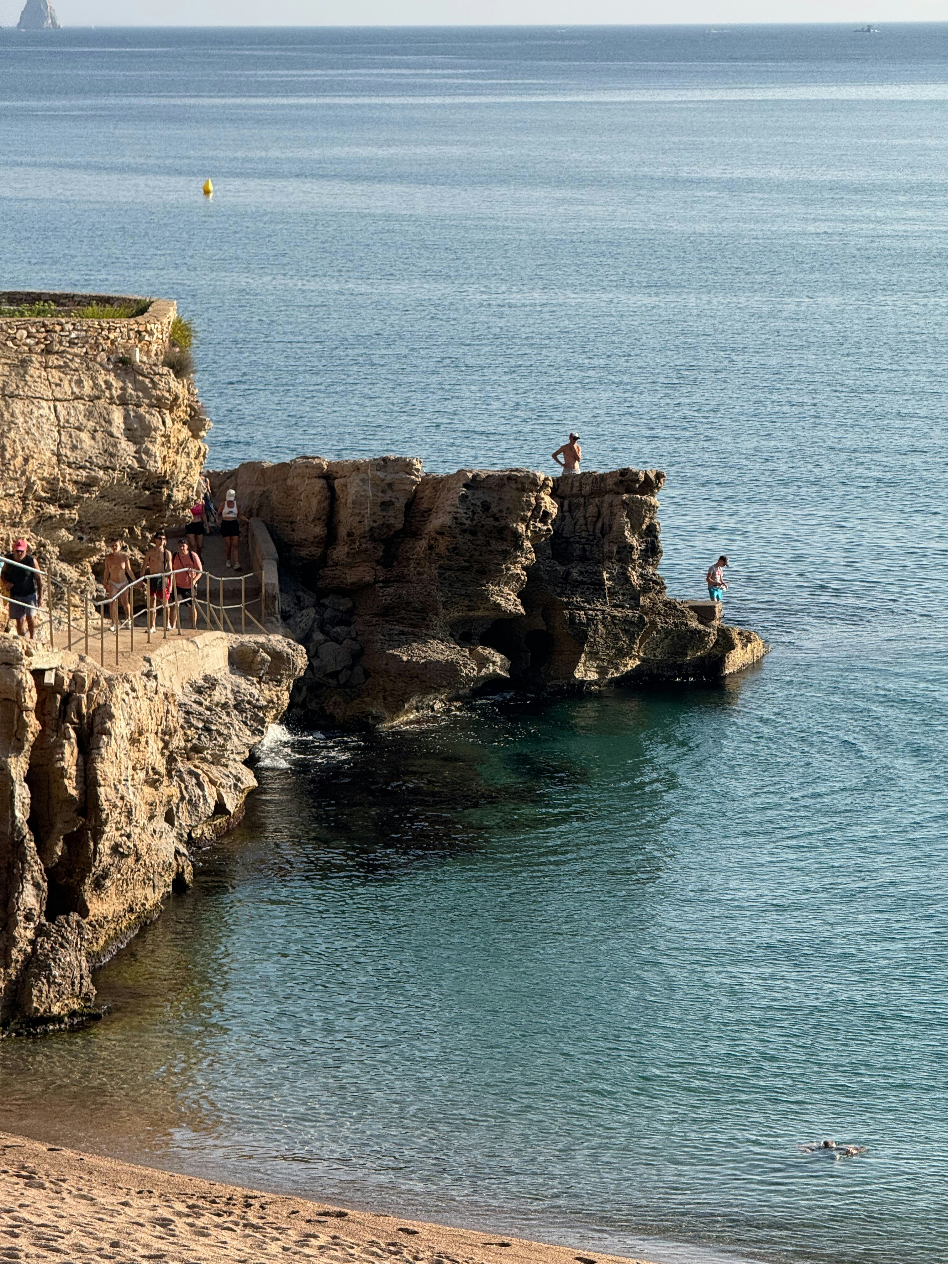 바위 절벽에서 맑고 푸른 물 속으로 뛰어내리는 사람들