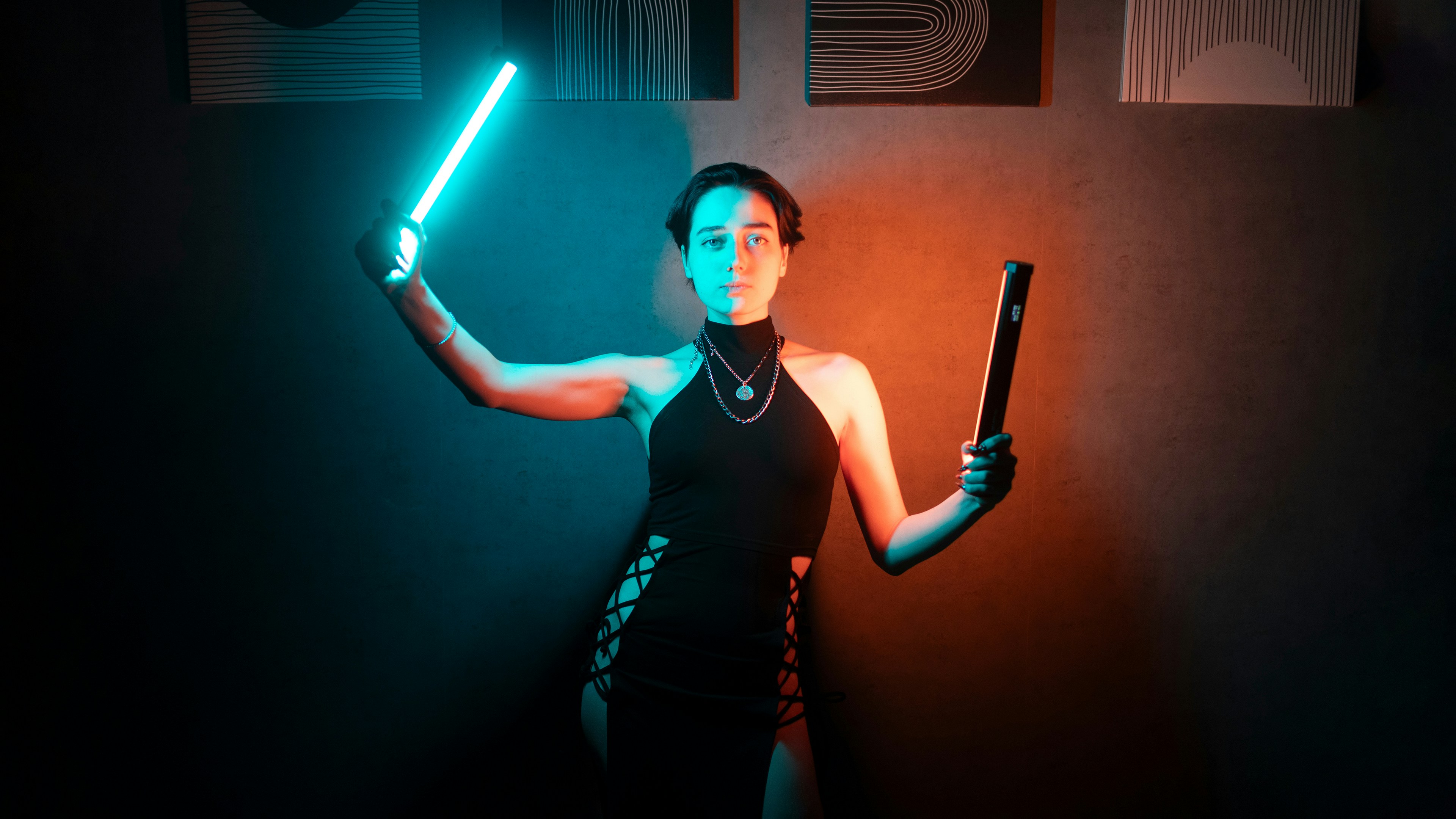 Woman holding glowing neon sticks