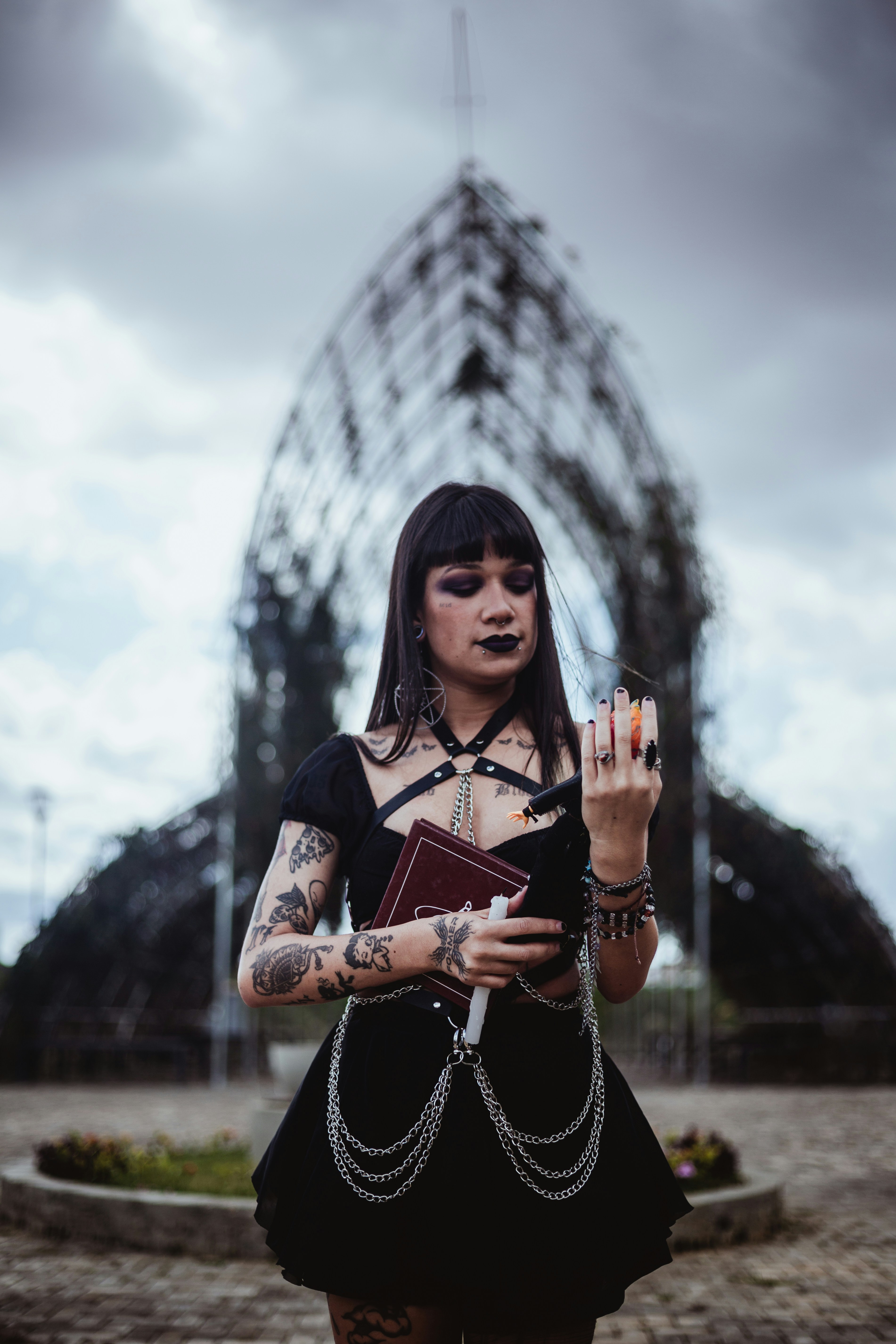 Woman in black holding a book and apple