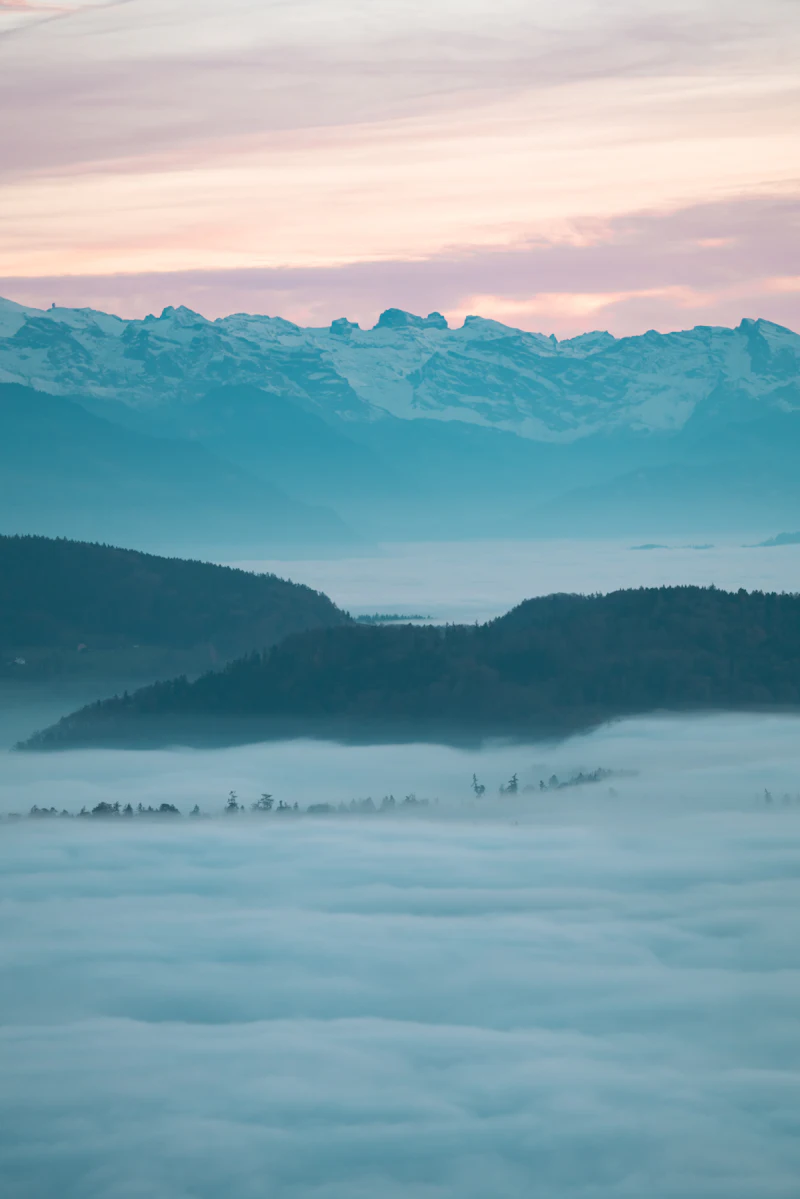 Misty mountain peaks catching the first light of morning.