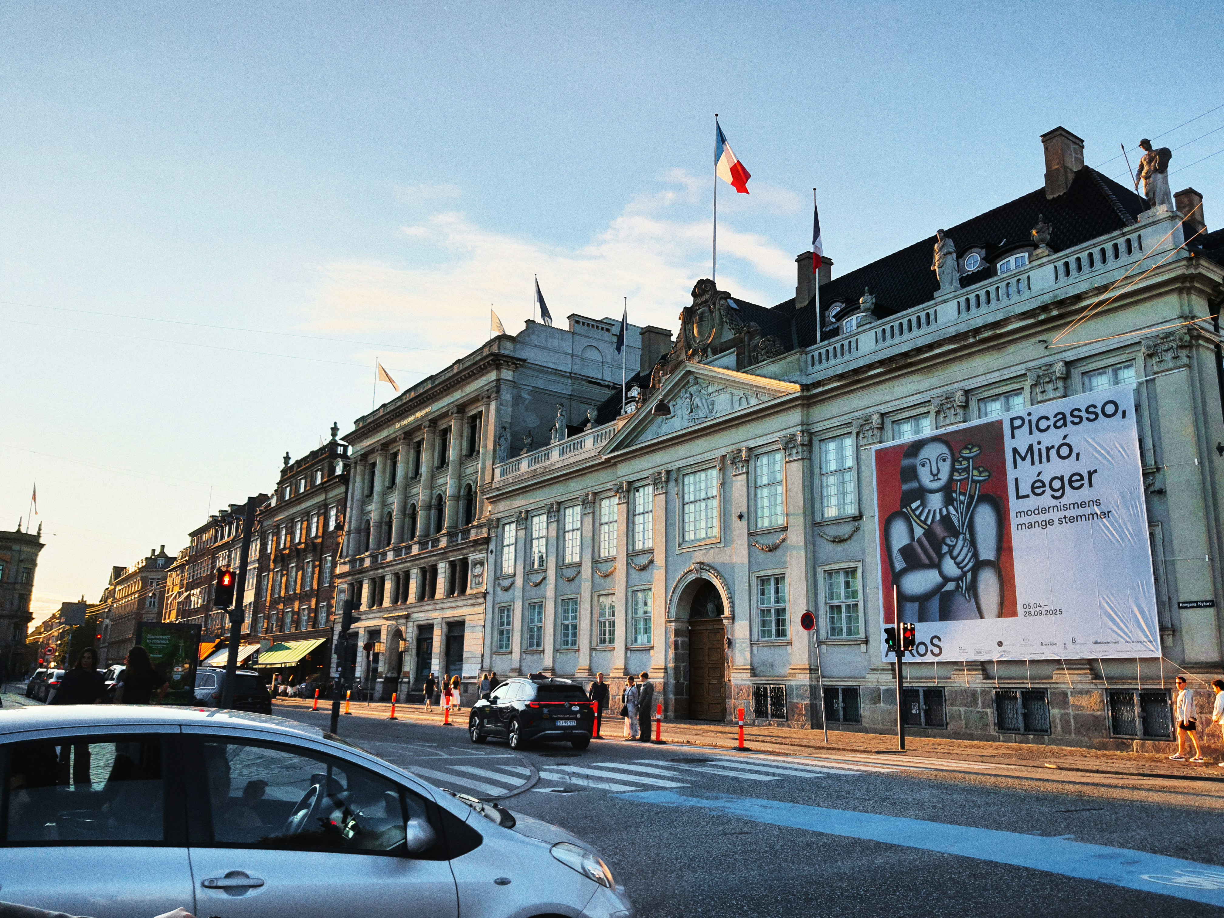Building with french flag and art exhibit banner.