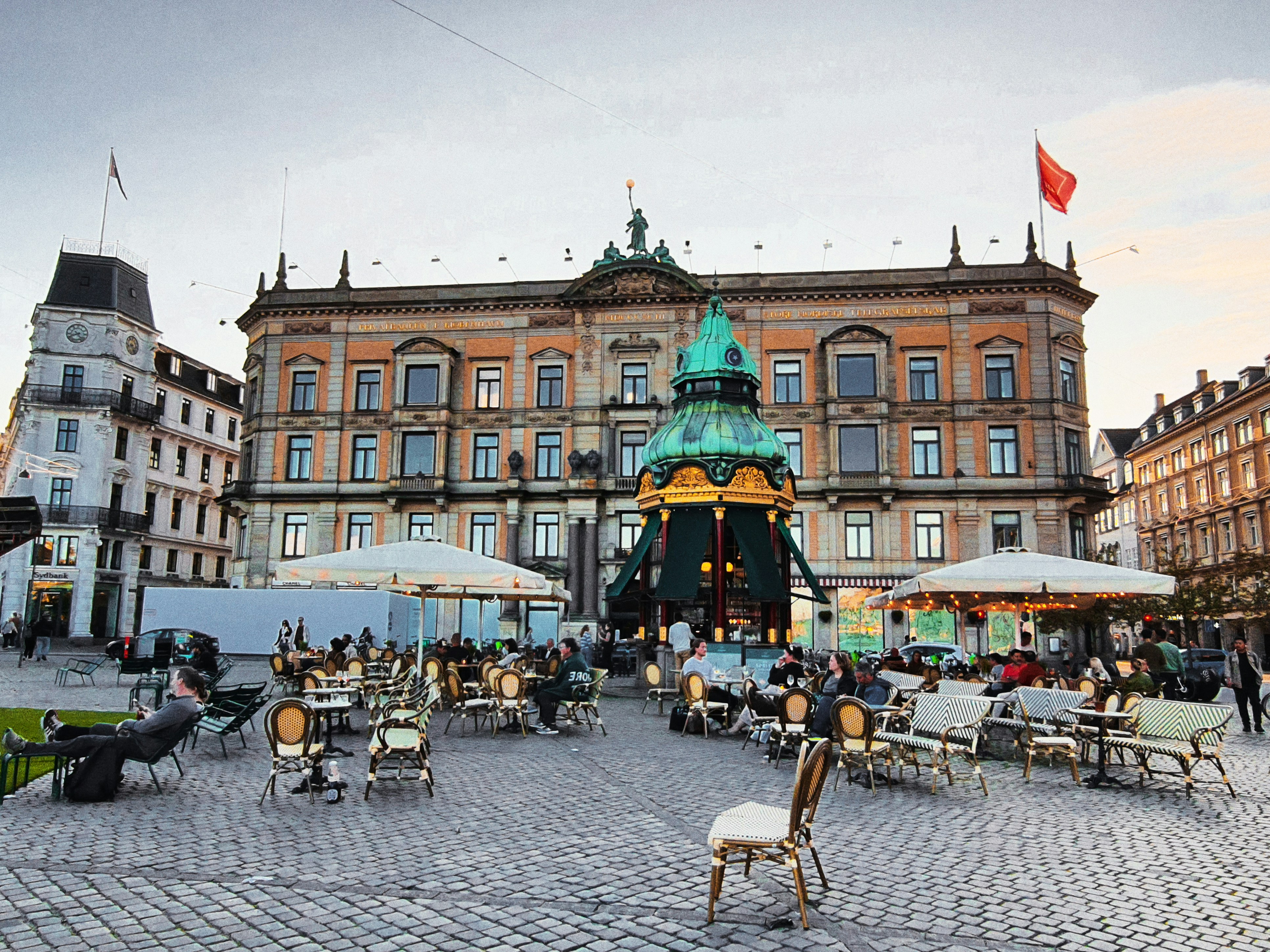 People relaxing at an outdoor cafe in a European town square