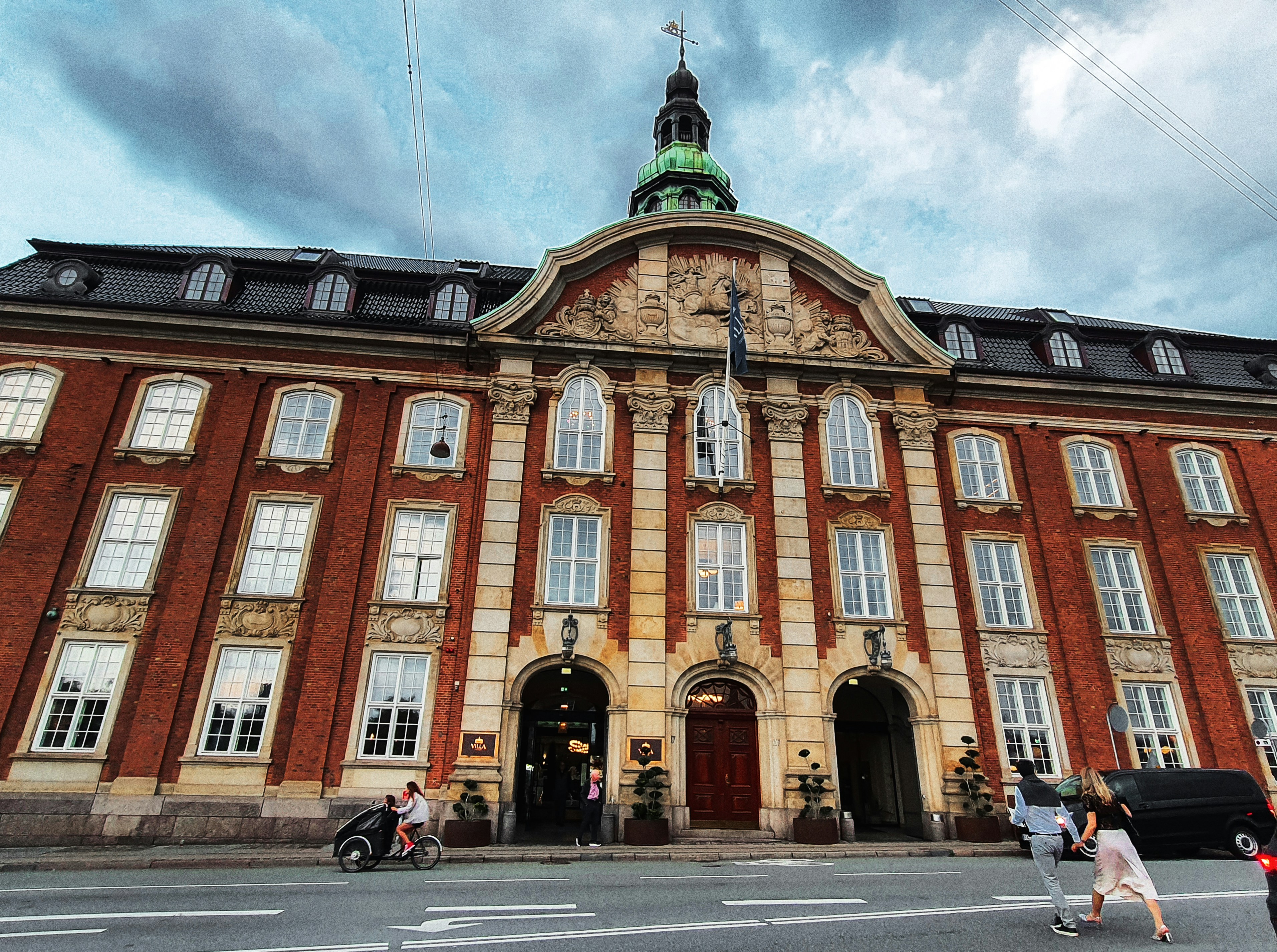 Ornate brick building with arched entrance and dome.