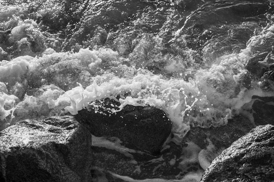 Pacific waves crashing against a rocky British Columbia coastline on a bright day