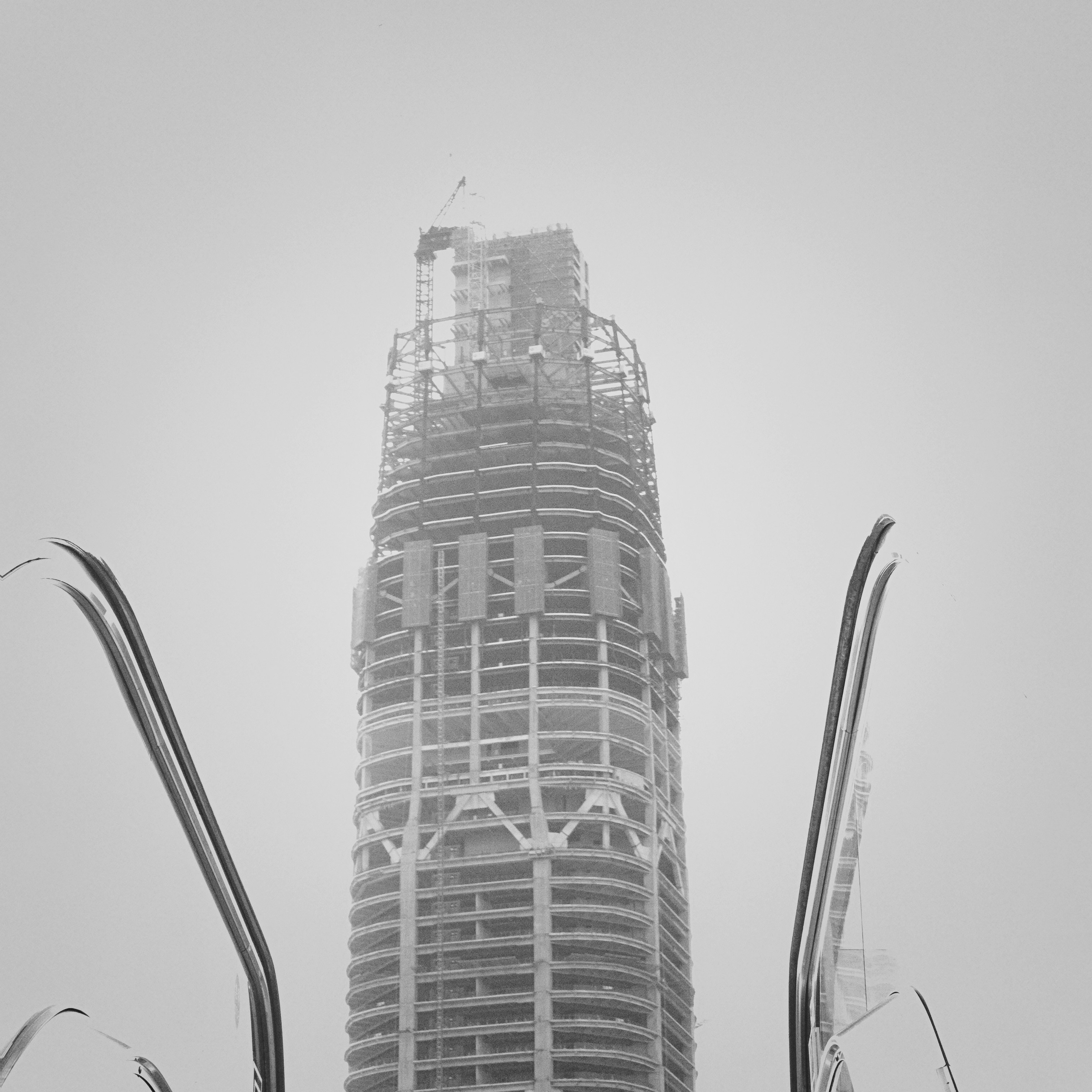Skyscraper under construction against a cloudy sky