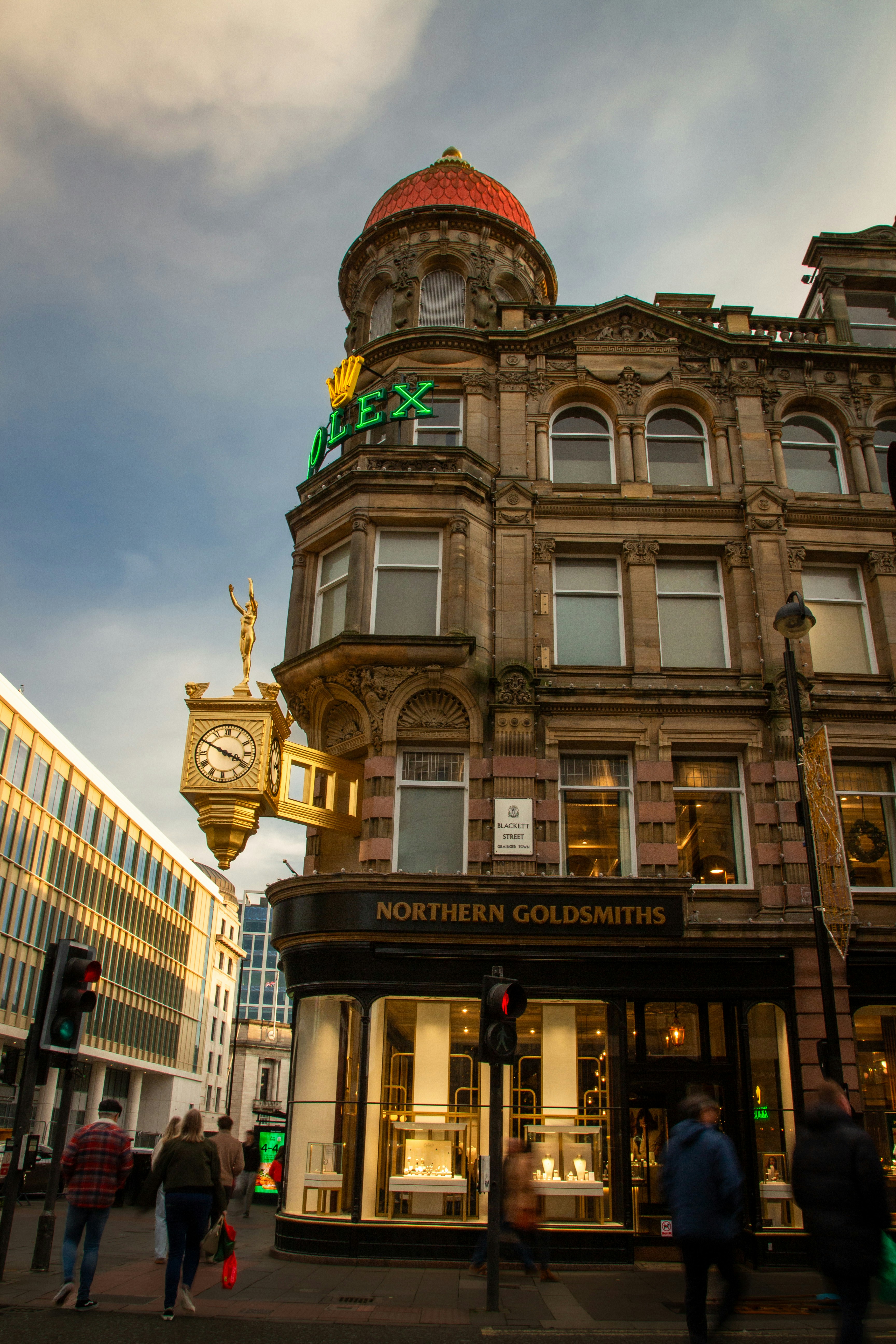 Corner building with rolex sign and clock