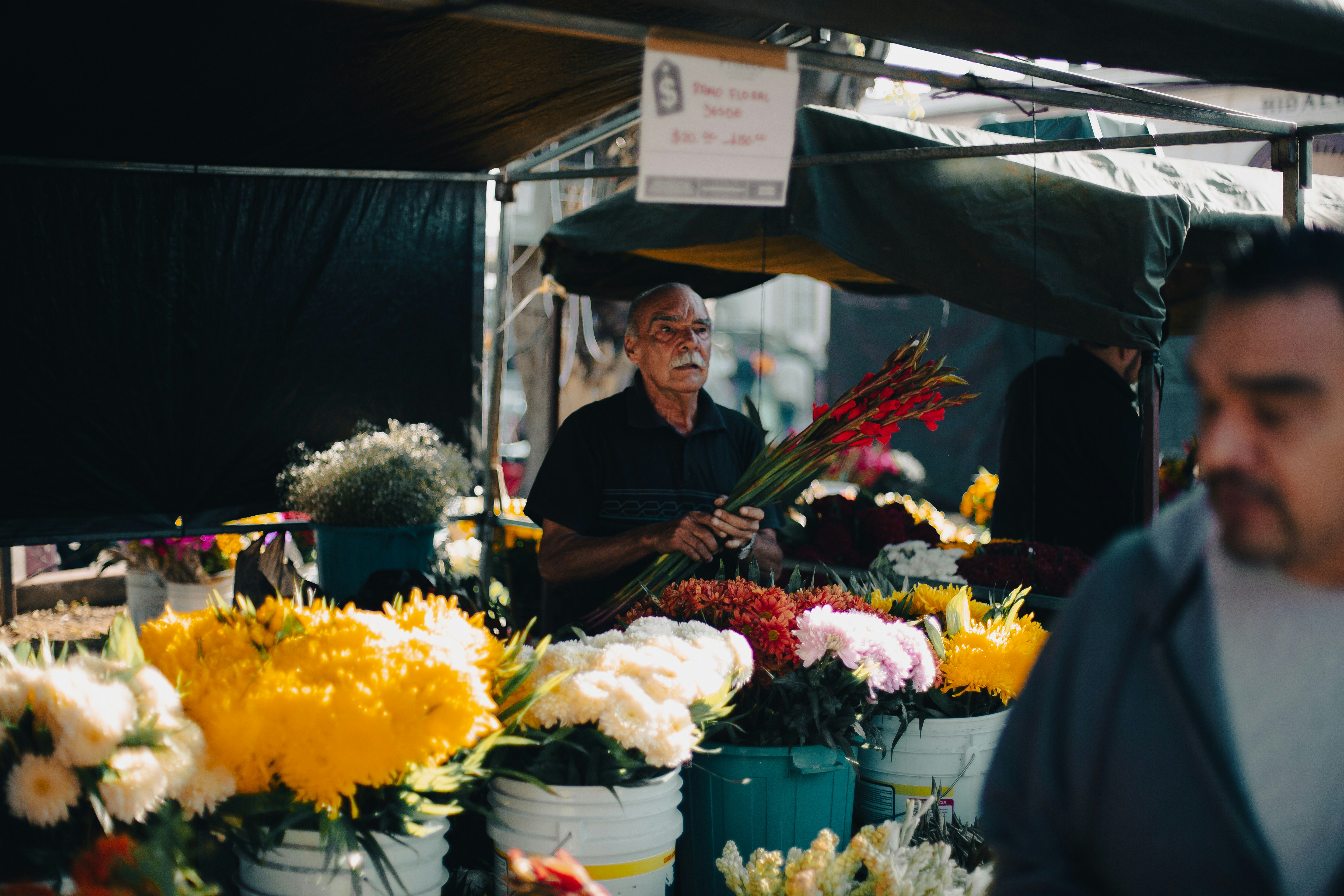 Man selling flowers at an outdoor market