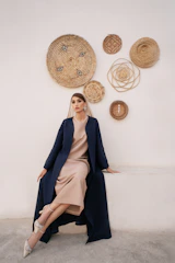 Woman in elegant navy coat and beige dress