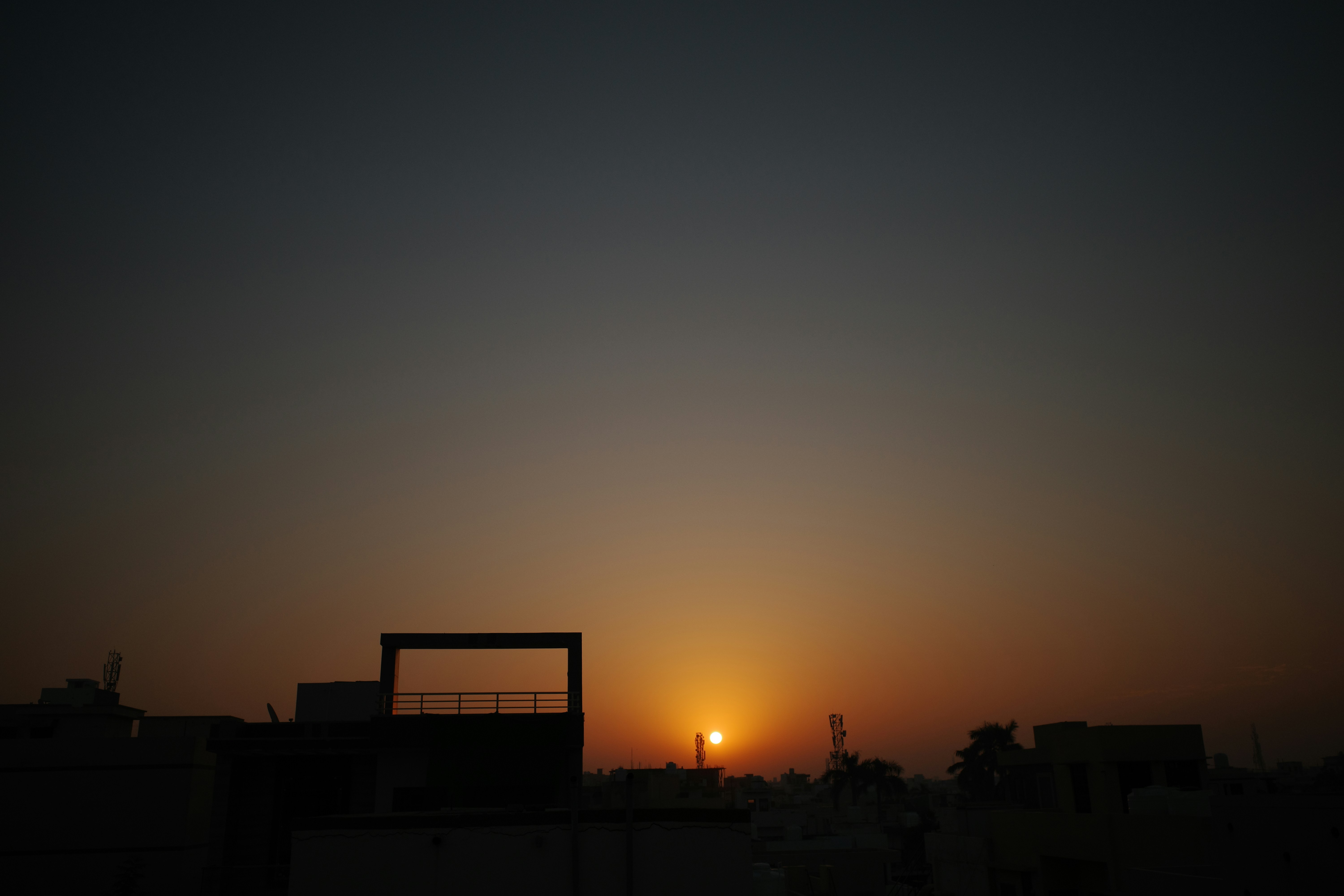 Sunset over buildings with a clear sky