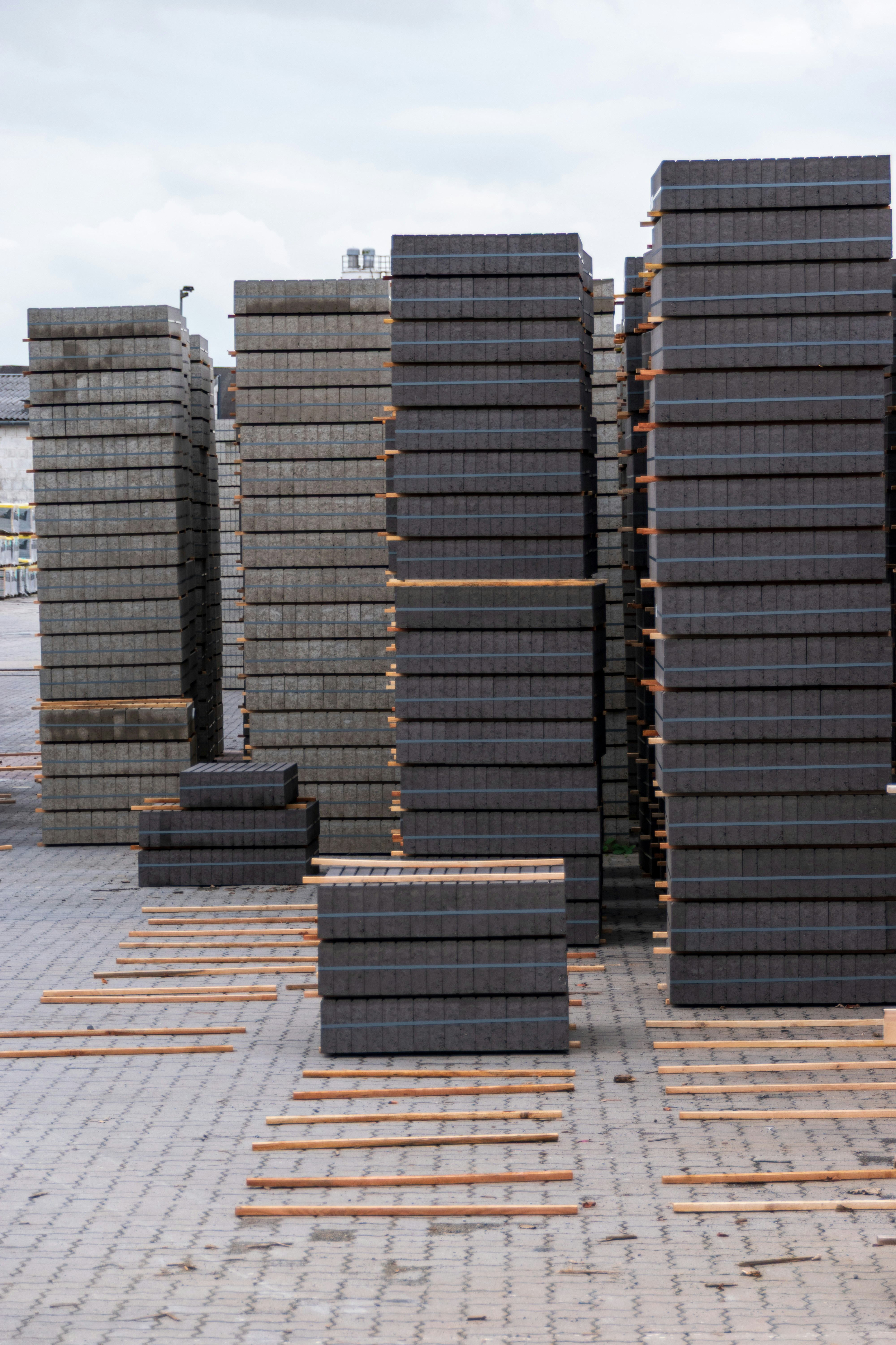 Stacks of grey paving stones on wooden pallets
