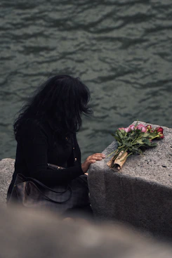 Woman with roses by the water