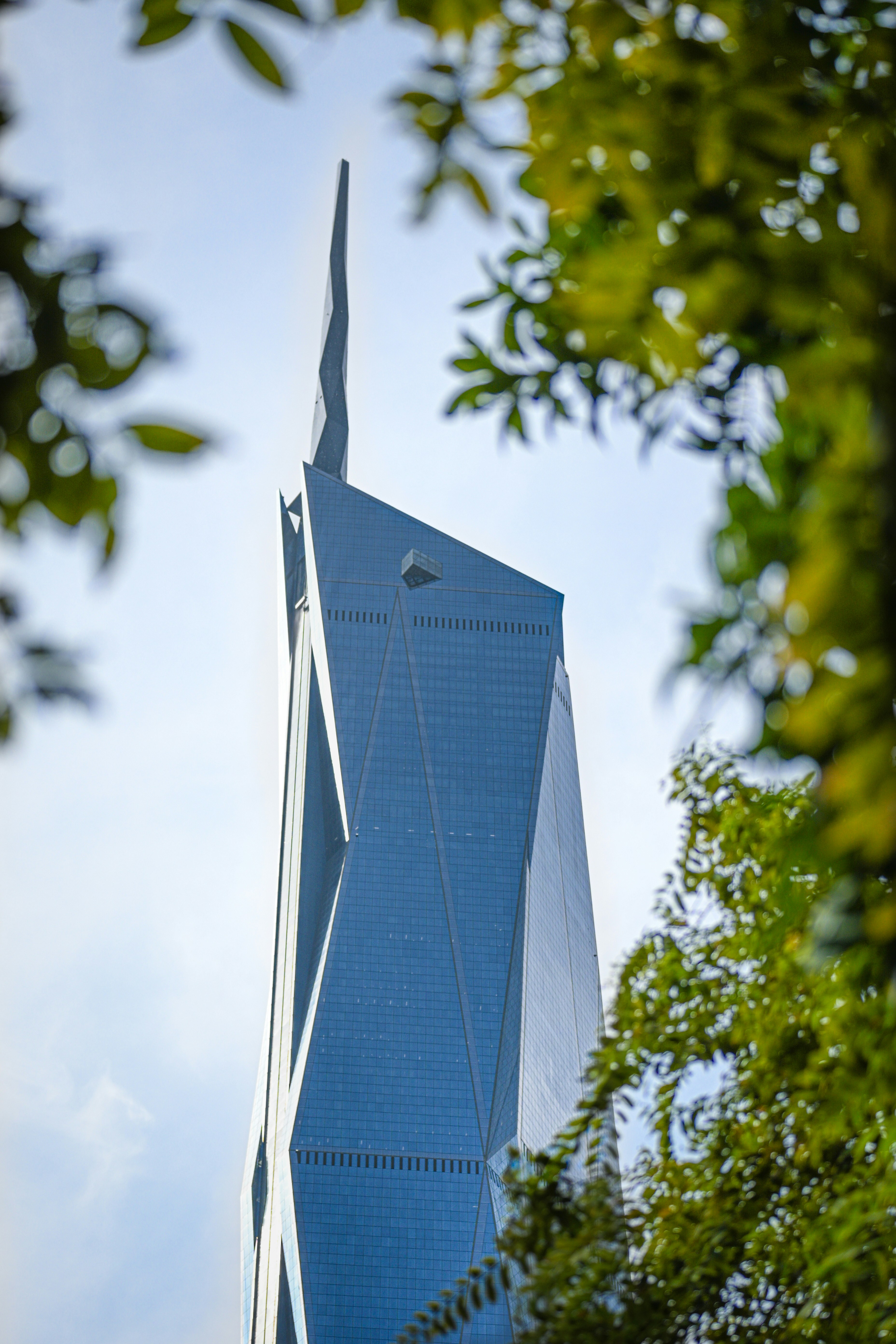 Modern skyscraper with unique geometric design framed facade.