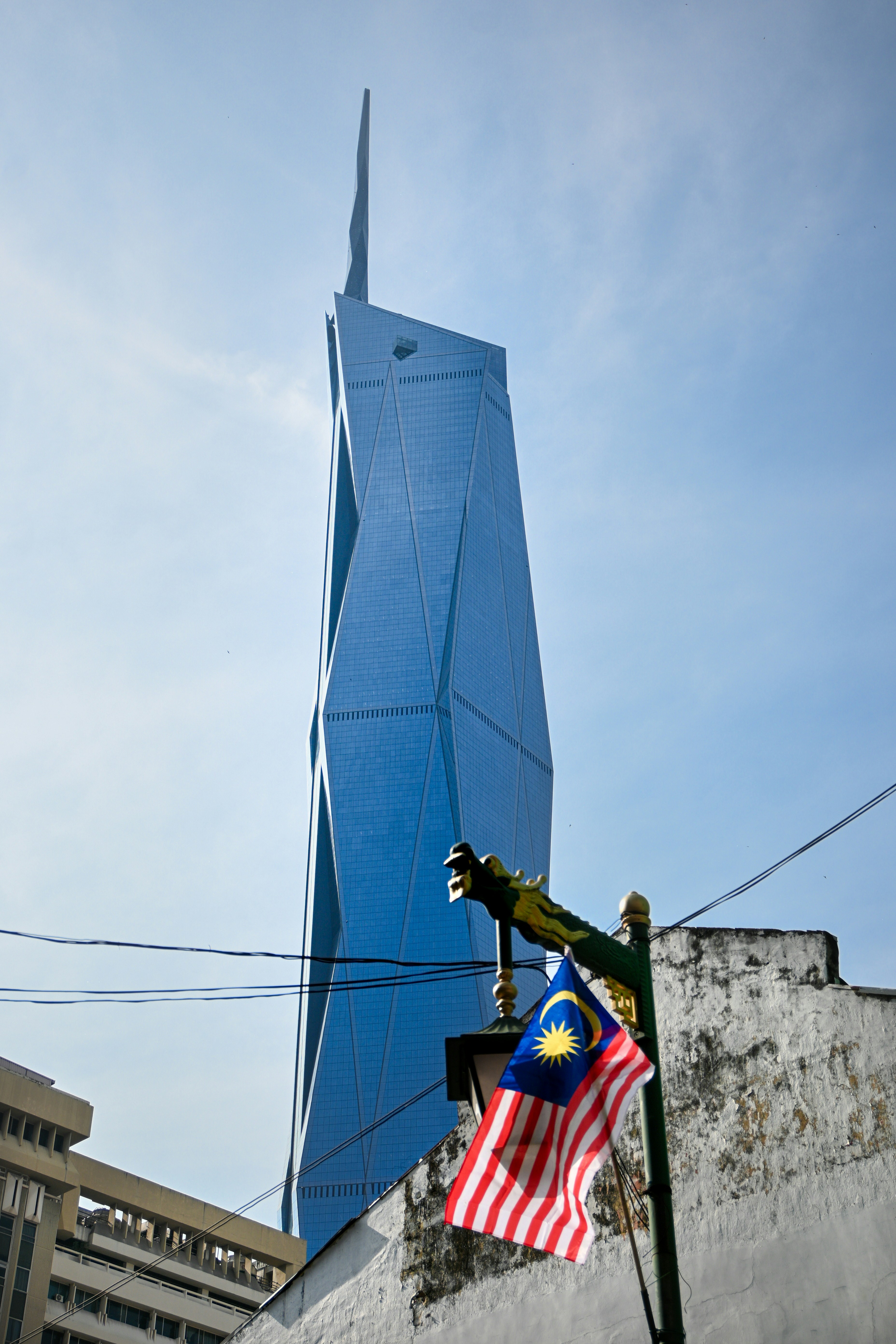Modern blue skyscraper with malaysian flag