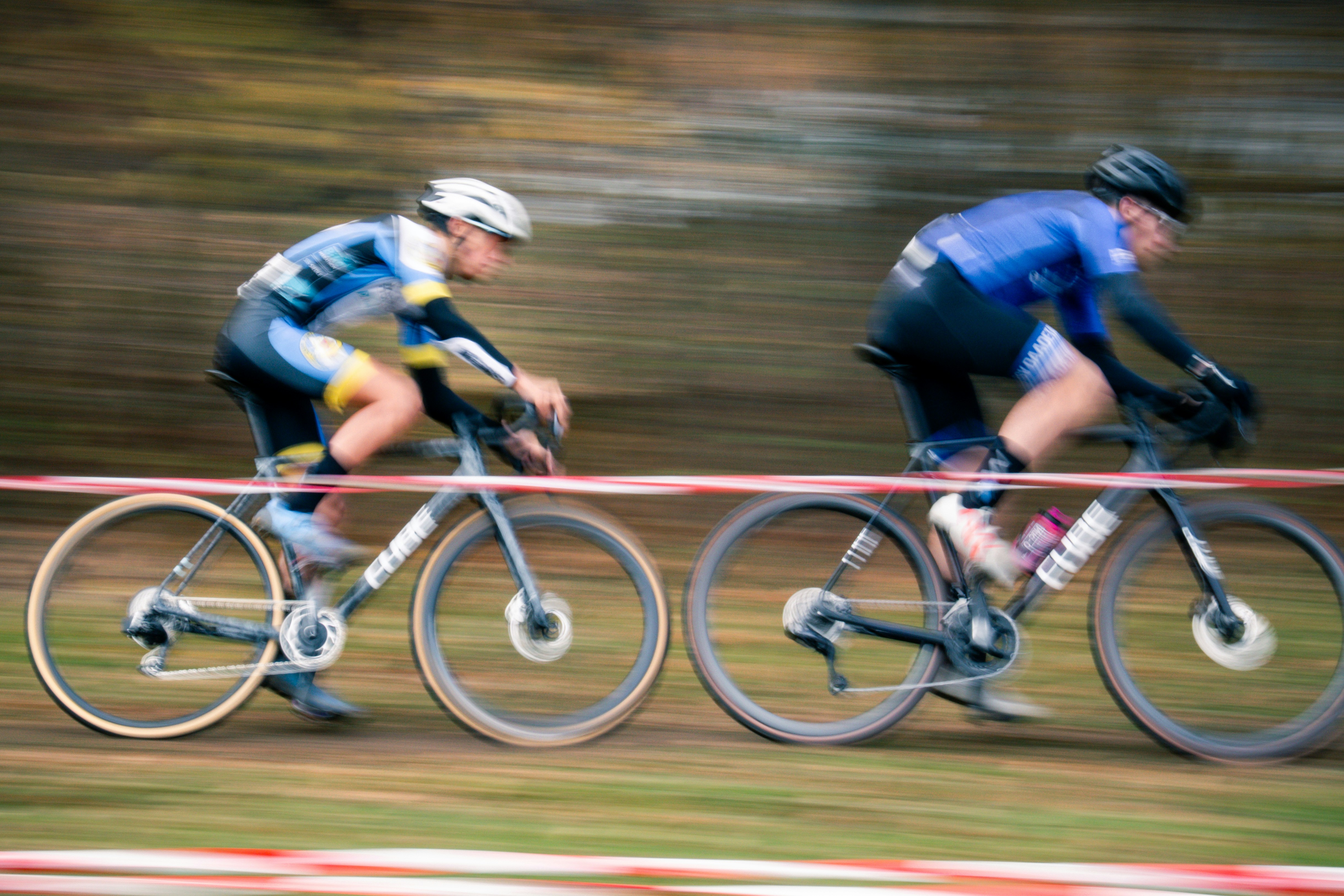 Two cyclists race on a dirt track