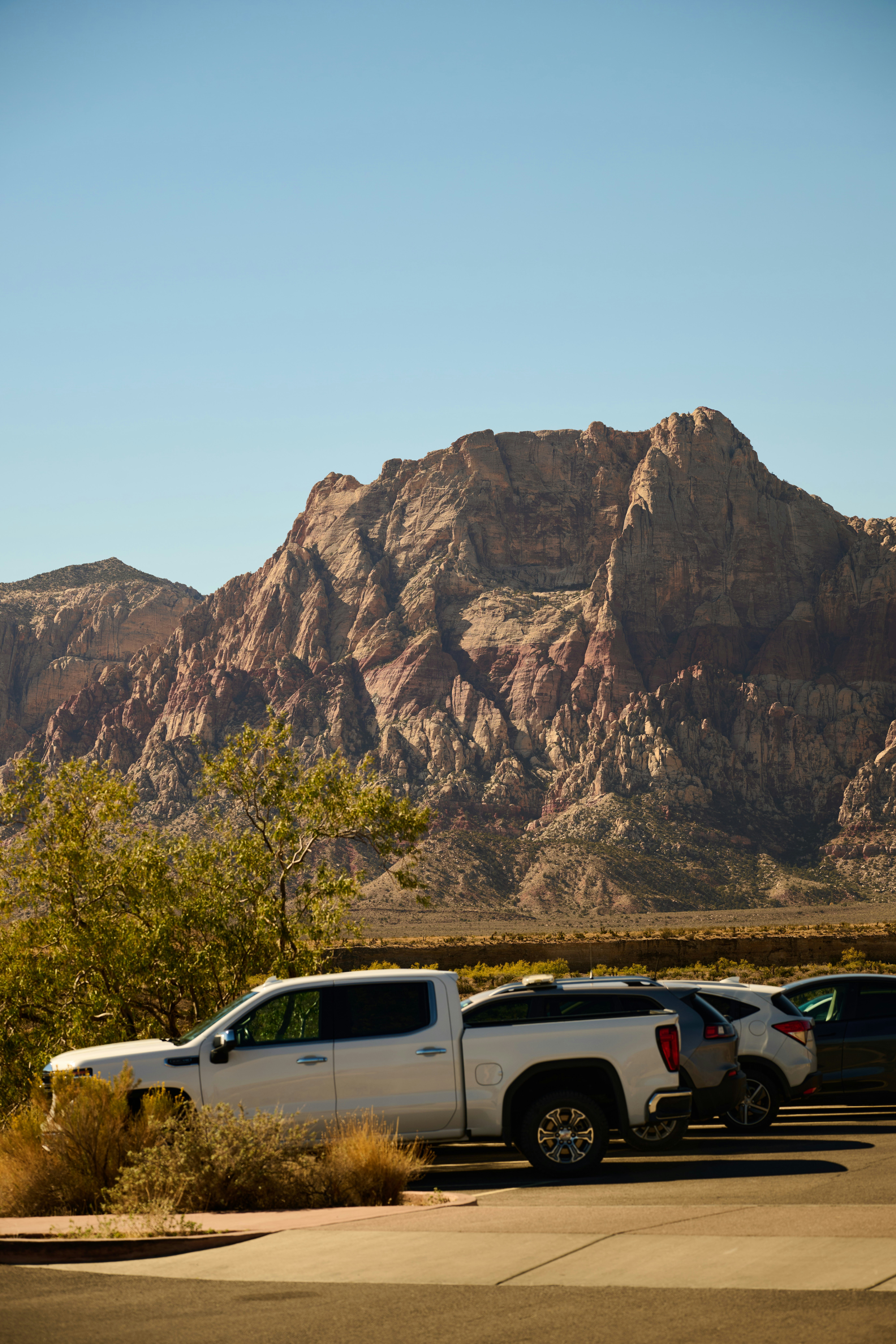 Cars parked with rocky mountains in background